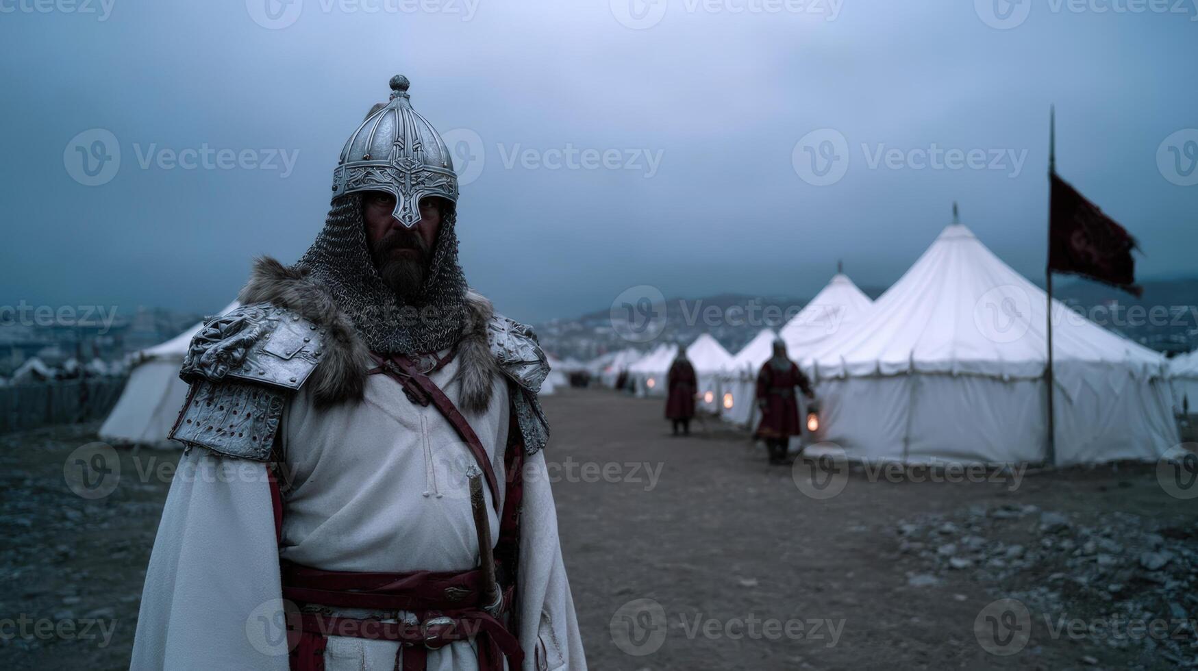 Historical reenactor in armor stands watch near medieval tents during dusk in a camp setting photo