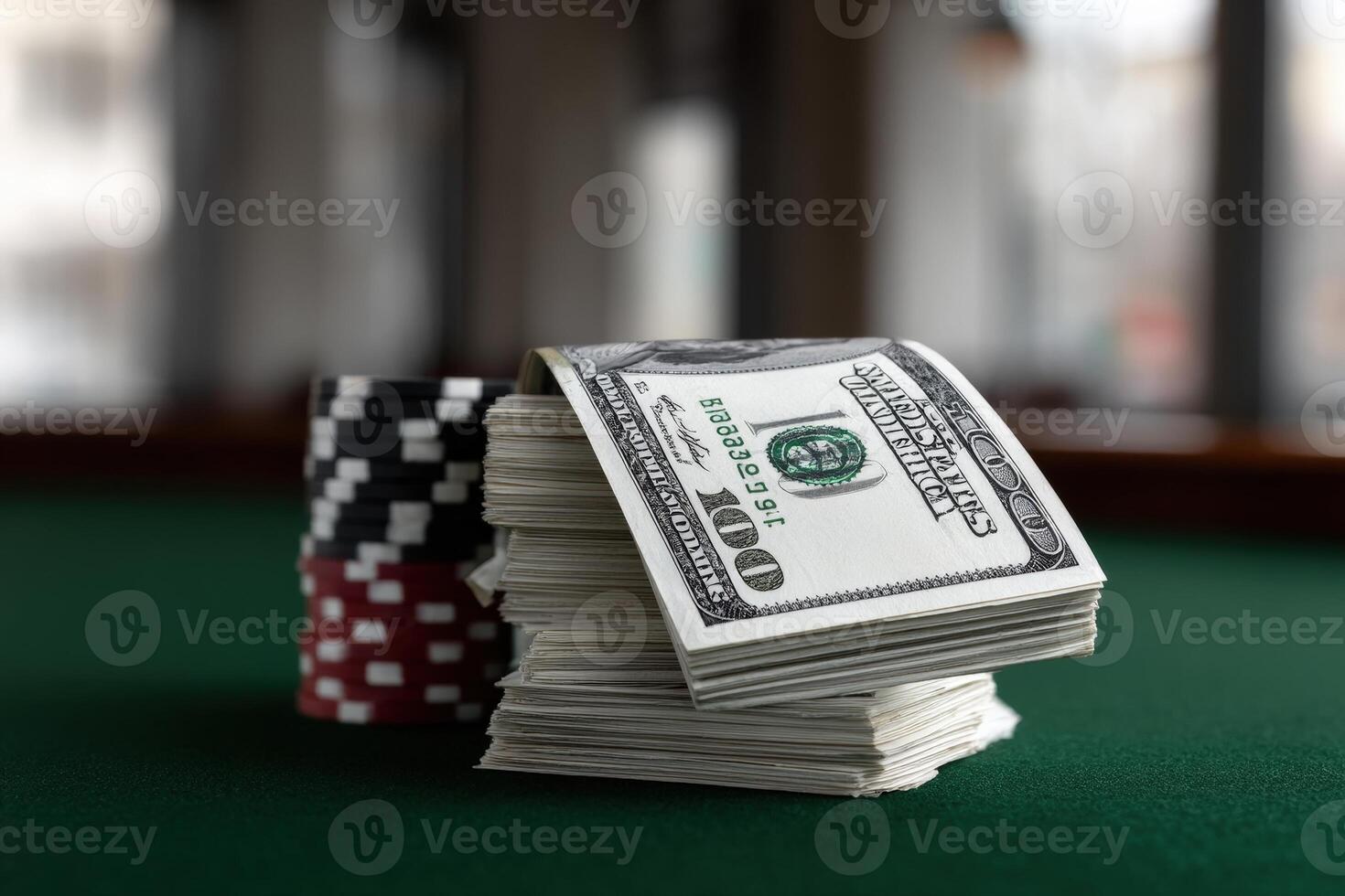 Stacked cash and poker chips on a green felt table in a gaming room photo