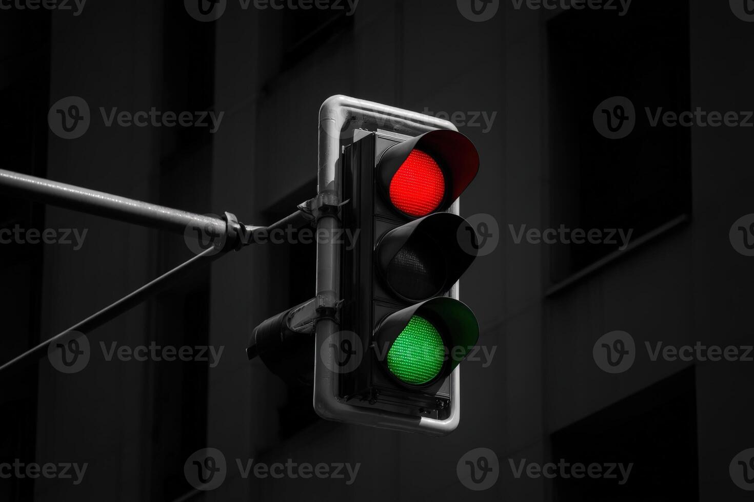 Traffic signal changes from red to green at a city intersection during the evening photo