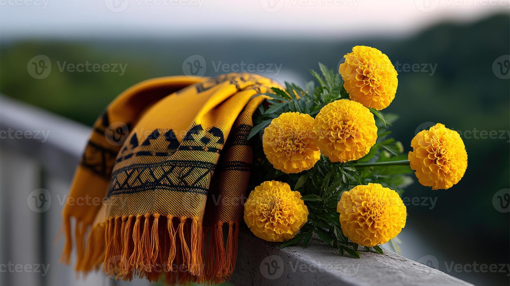 Bright yellow marigolds adorned with a traditional scarf on a balcony overlooking a lush landscape photo