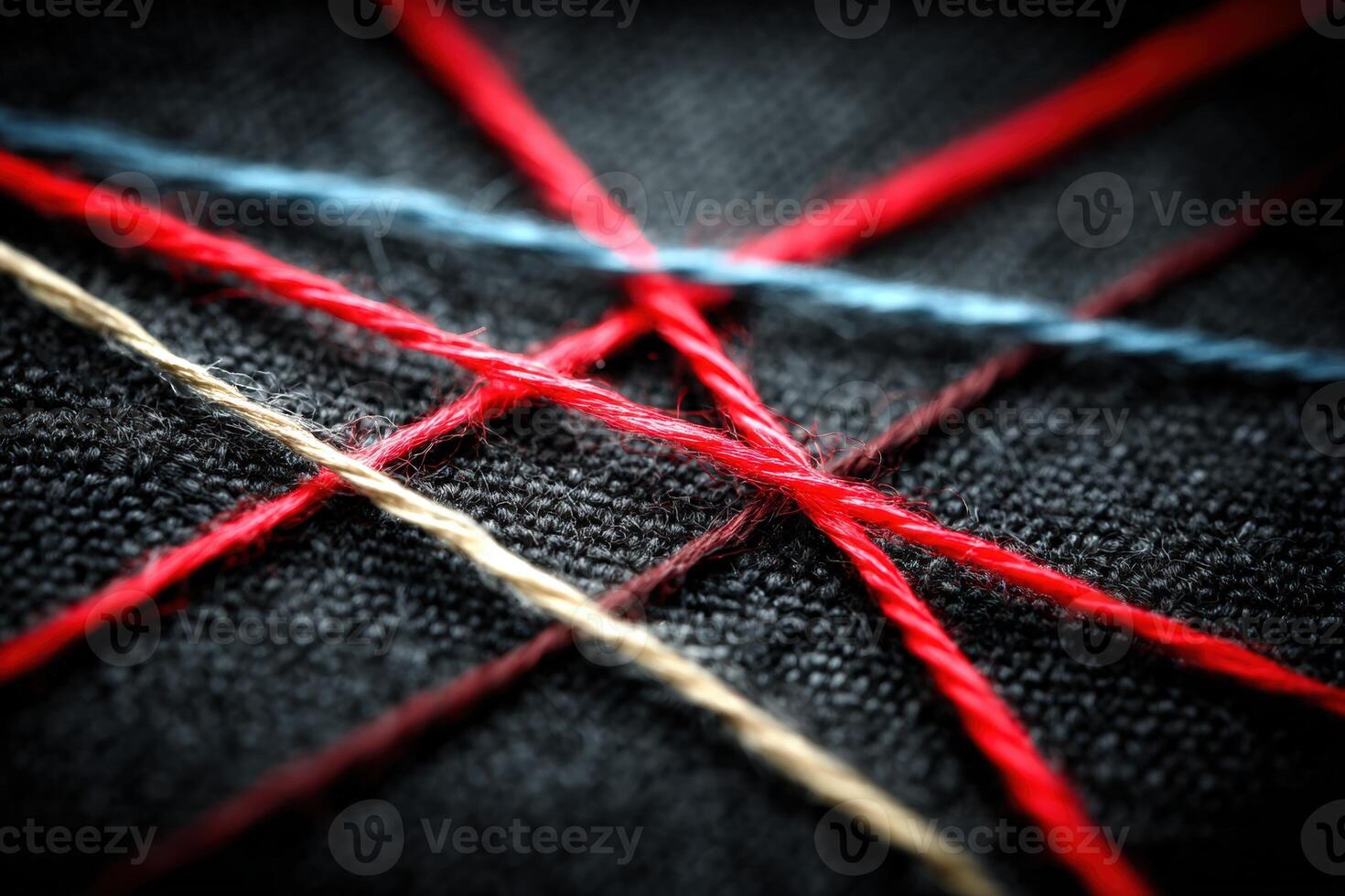 Colorful threads crossing on dark fabric create an intricate pattern of texture and craft photo