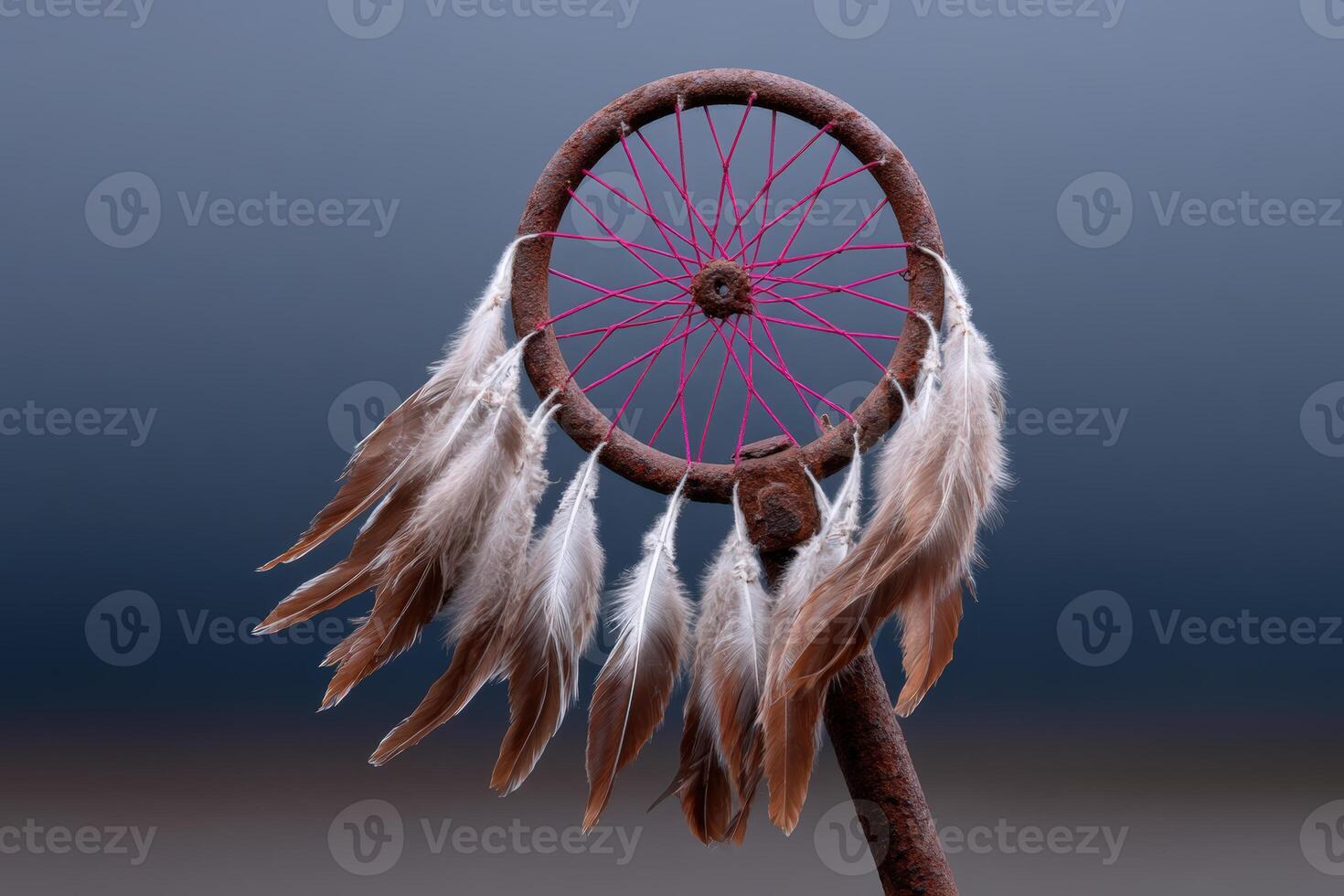 Bike wheel transformed into a colorful dreamcatcher with feathers on a soft background photo