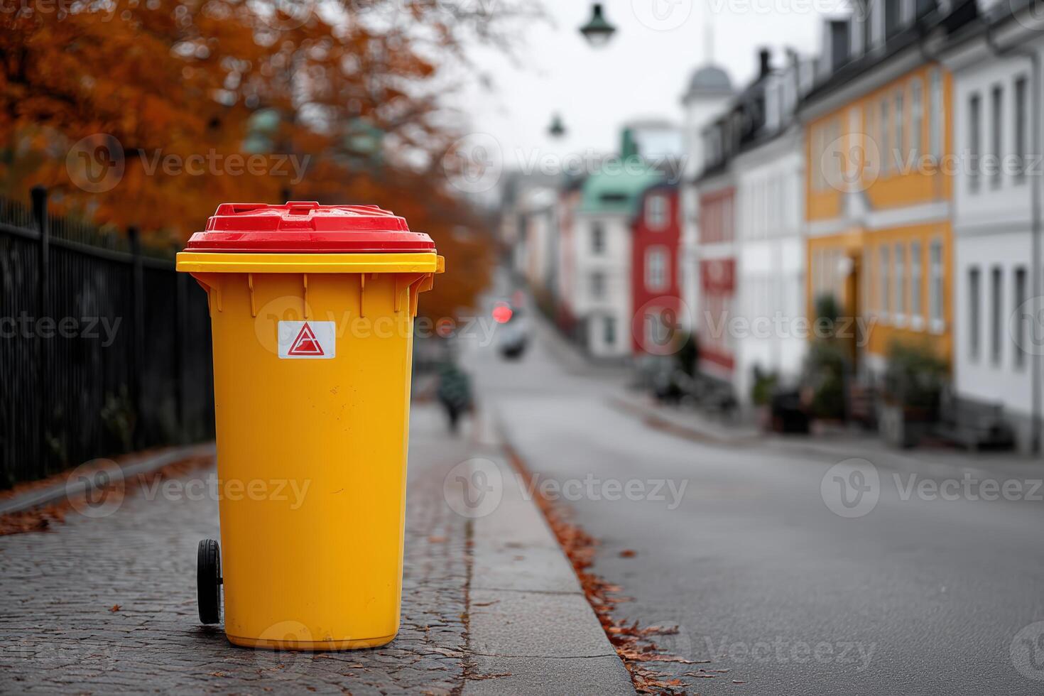 Waste bin located on a street with incorrectly sorted materials during autumn season photo