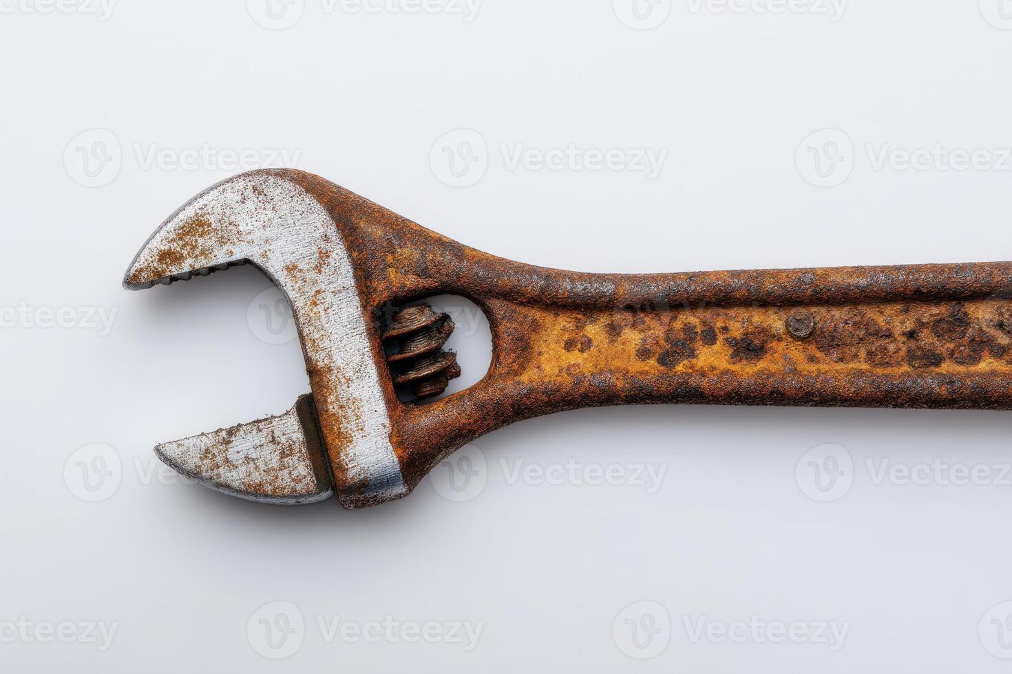 Wrench showing deep rust pits and worn grip in a workshop setting photo