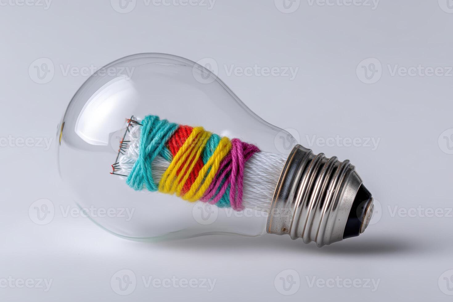 Creative light bulb filled with colorful yarn and thread showcasing unique design concept photo