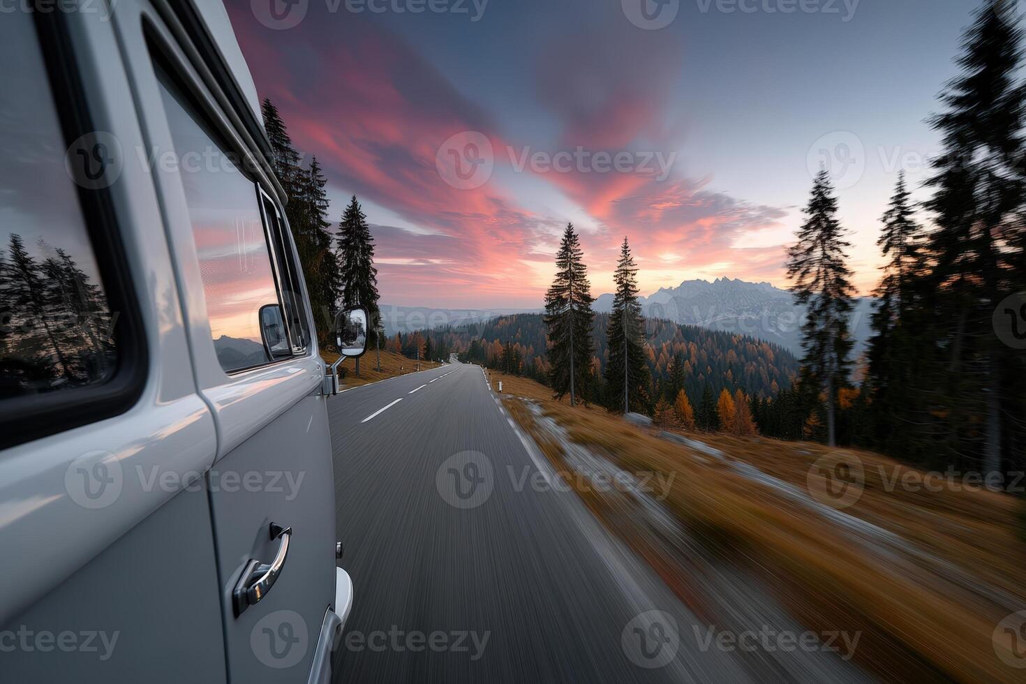Couple enjoys sunset road trip in vintage RV through mountainous landscape photo