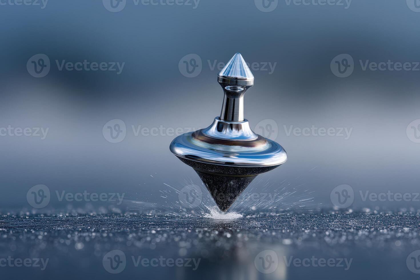 Spinning top rotates gracefully on a smooth surface with water droplets around photo
