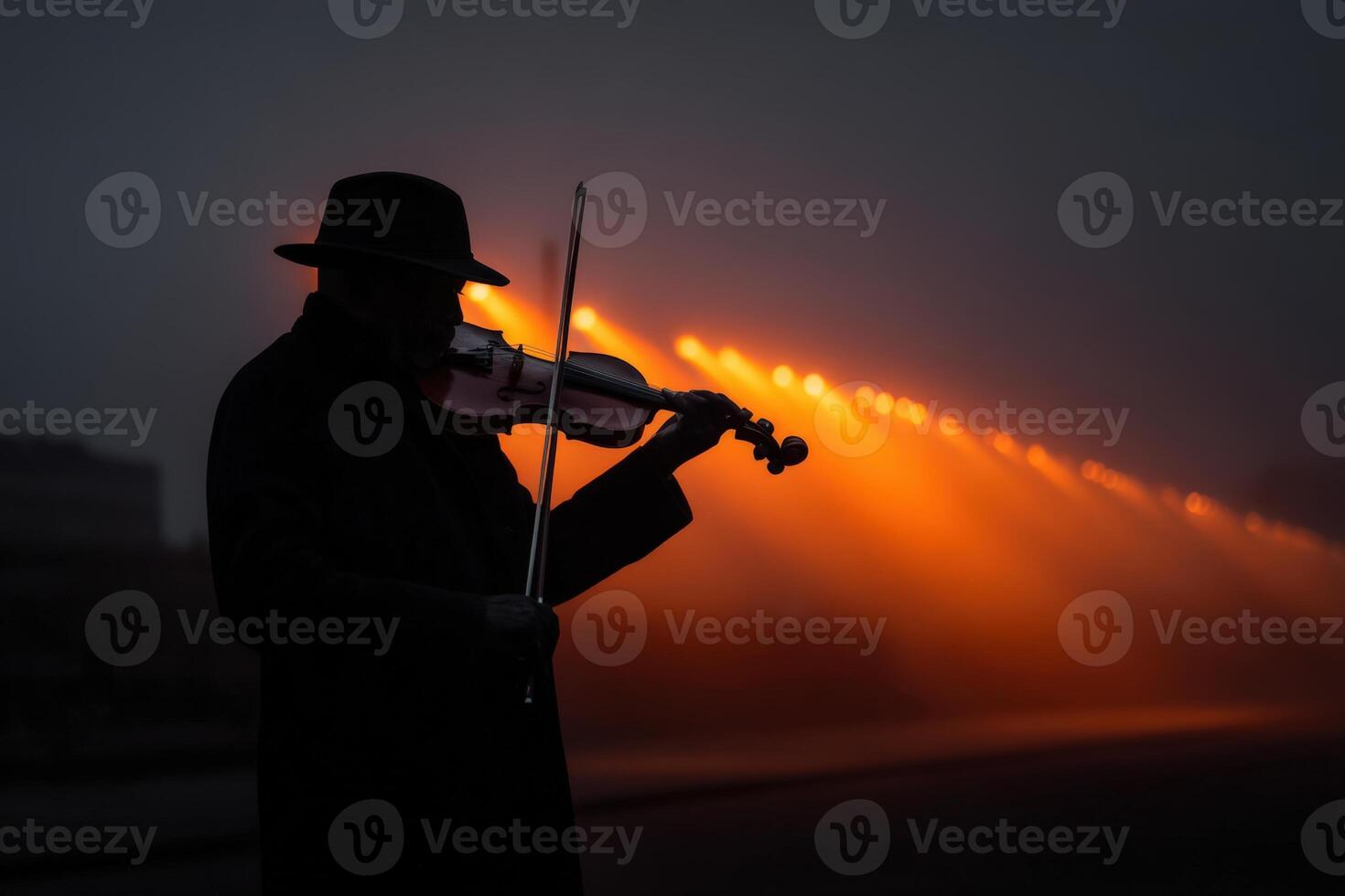 Violinist performs captivating music in the night under glowing lights photo