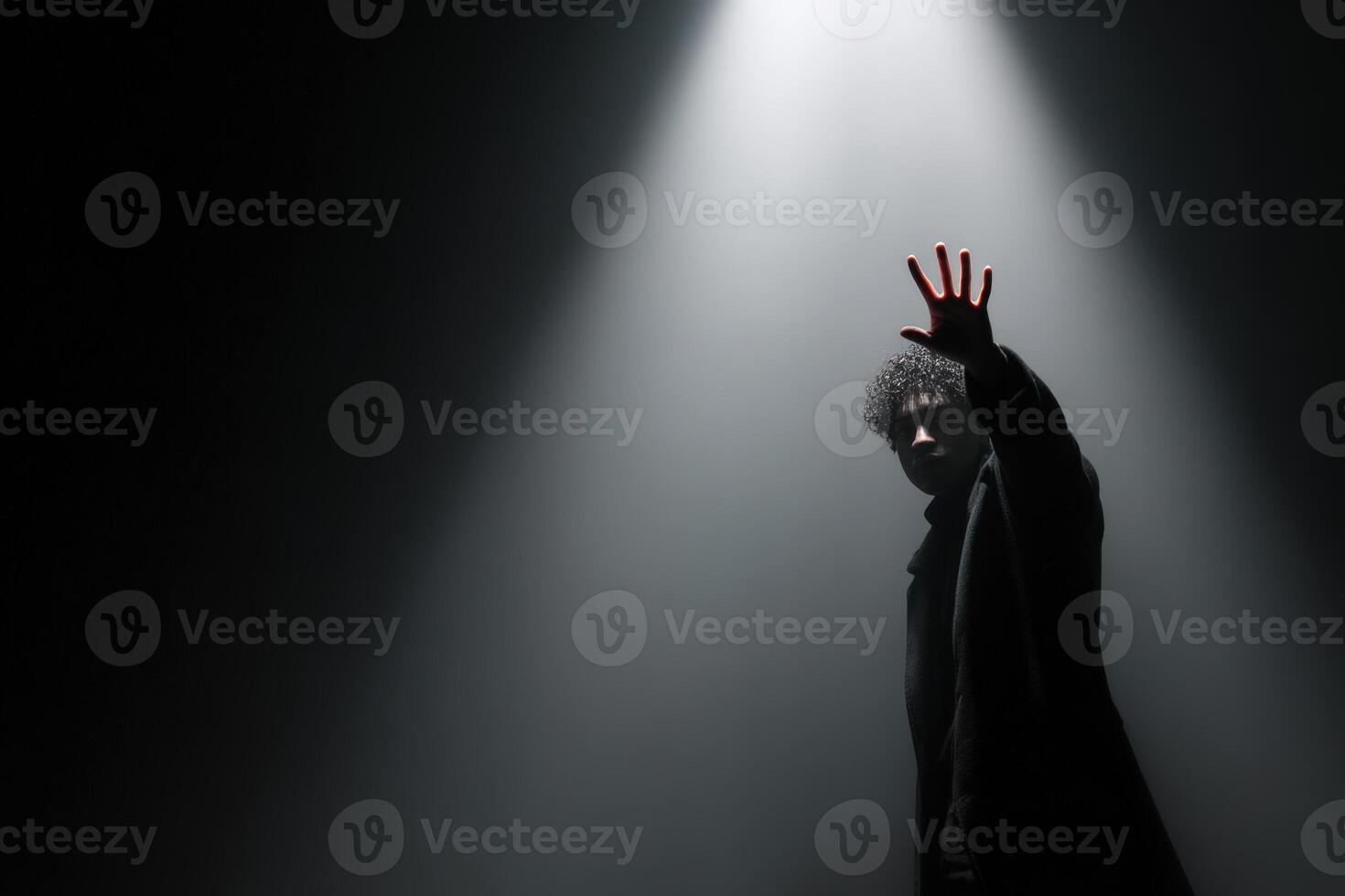 Reaching for the shadow on stage during a captivating performance photo