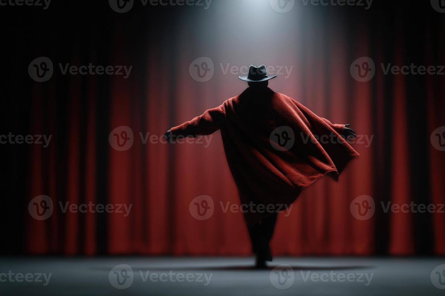 Old theater actor performs dramatically in front of red curtains under spotlight photo
