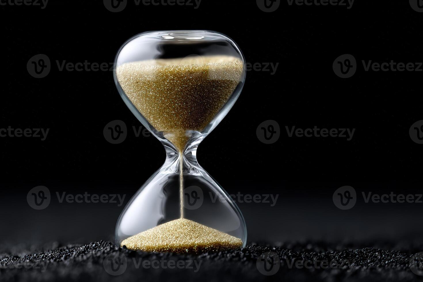 Glowing particles fill the hourglass, marking the passage of time in a dark setting photo