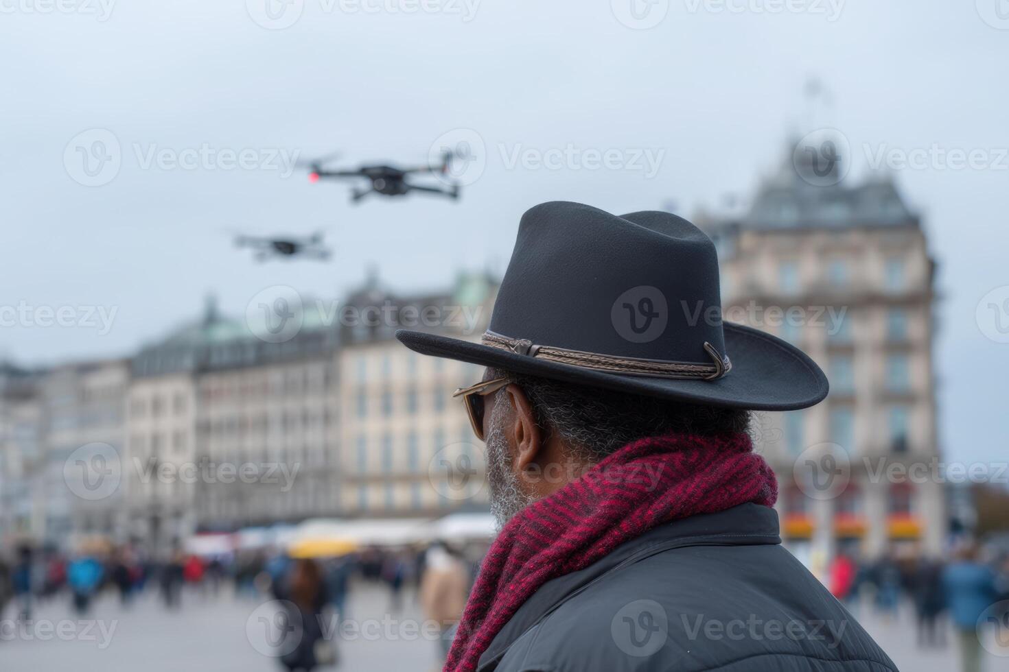 Wrangler directing flying bots in busy urban square at dusk photo