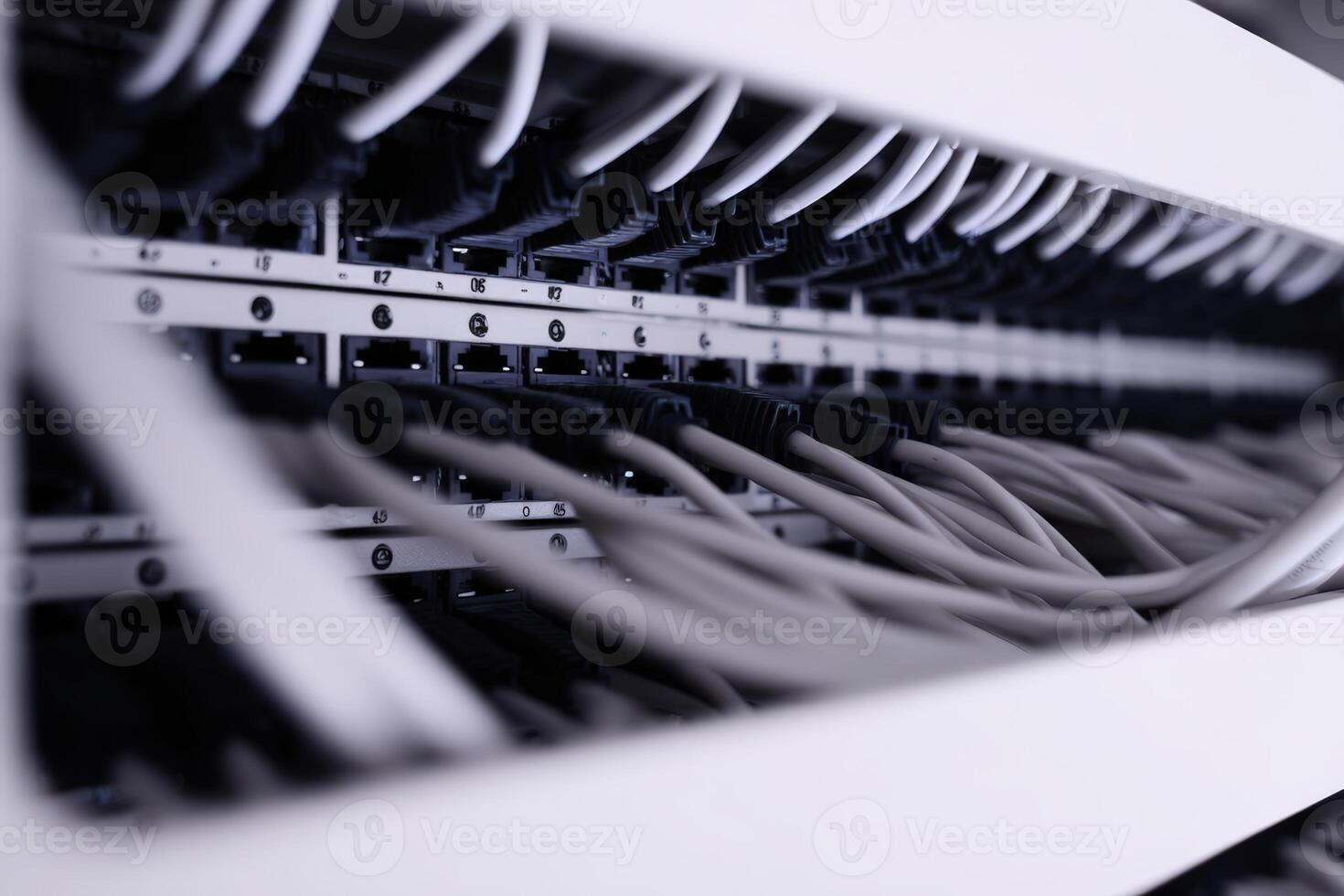 Detailed view of patch panel wiring with hidden cables in a network setup photo