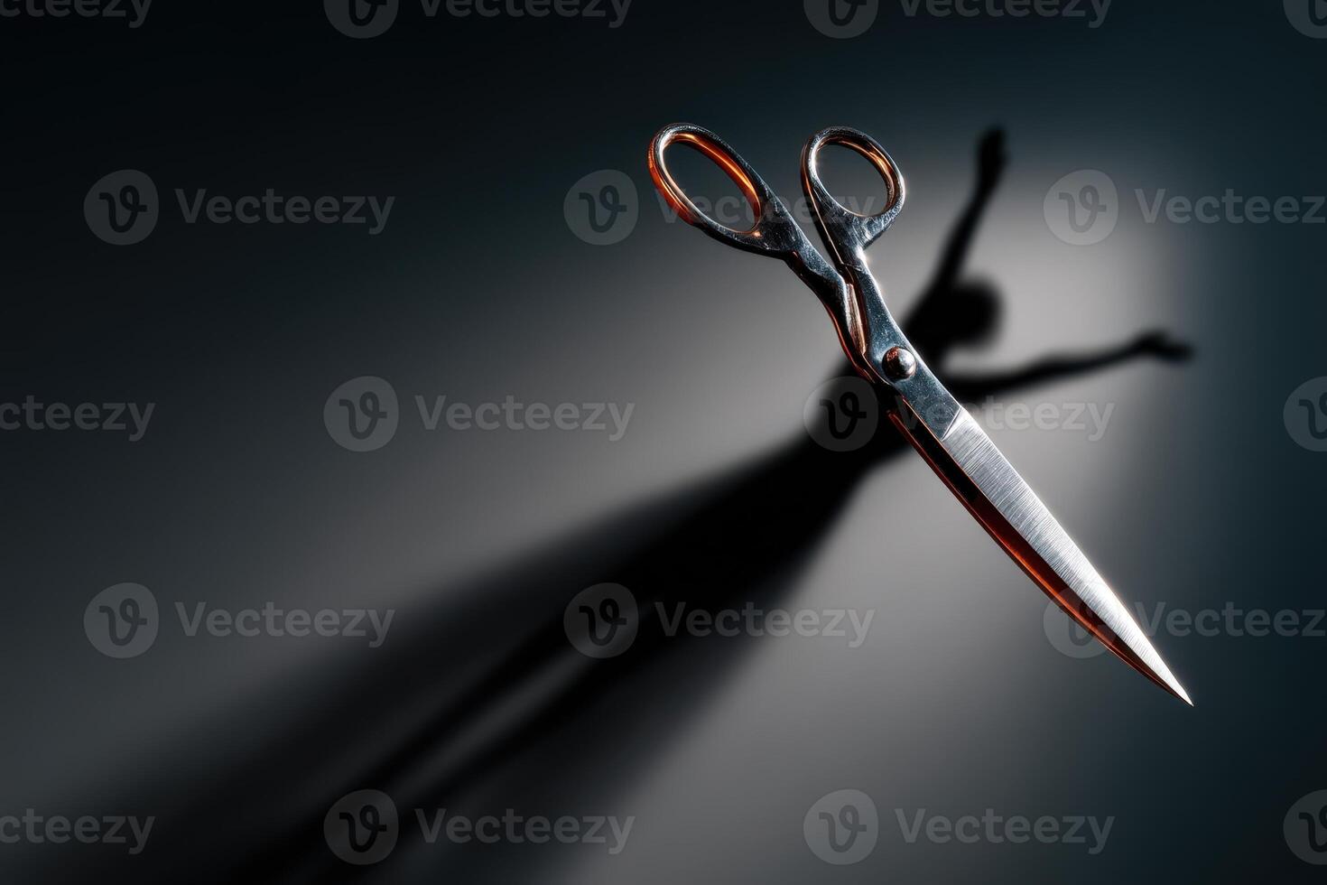 Scissors casting a shadow resembling a dancing figure on a dark background photo