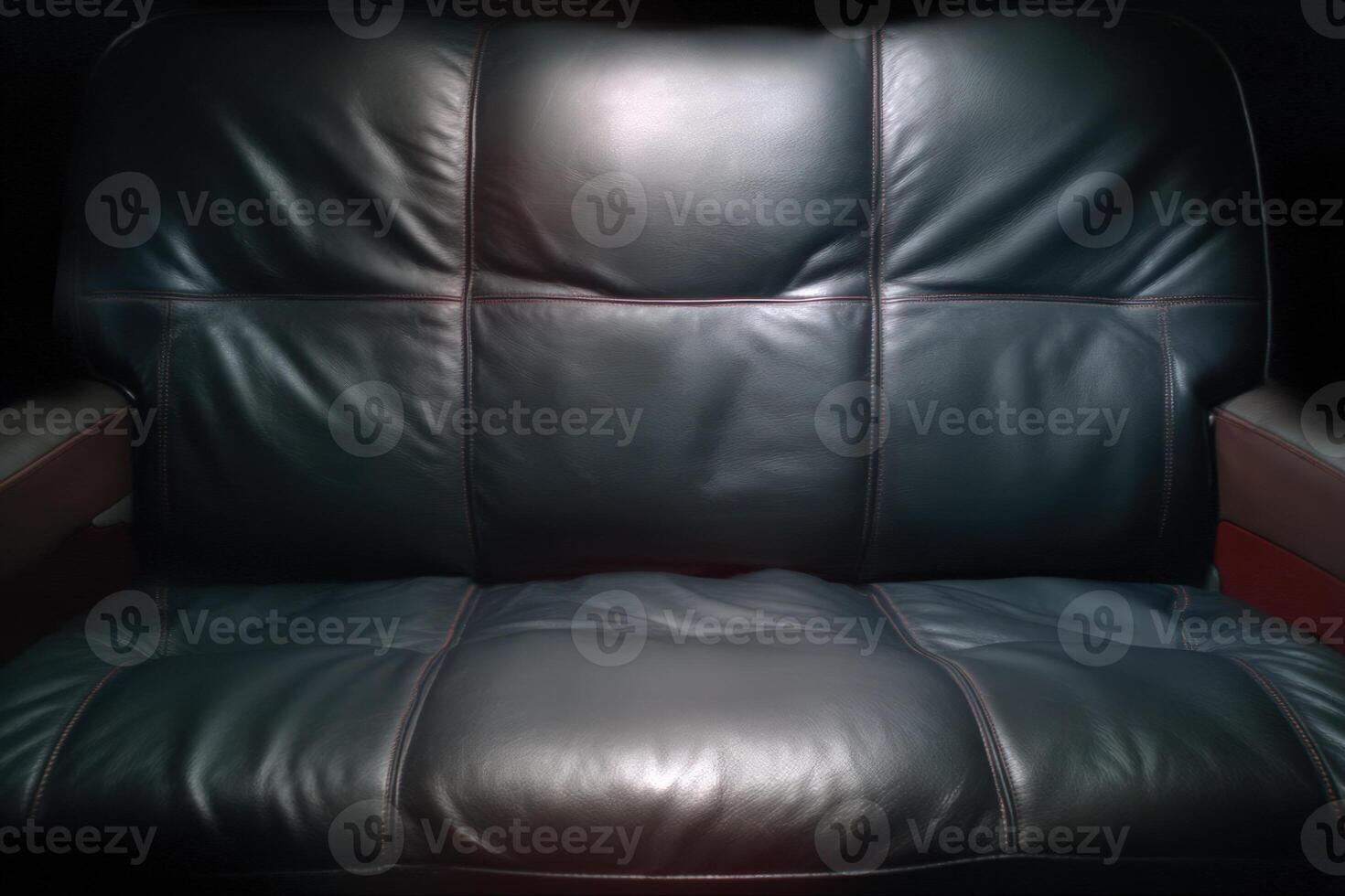 Close-up view of a dark leather couch showcasing texture and color in macro perspective photo