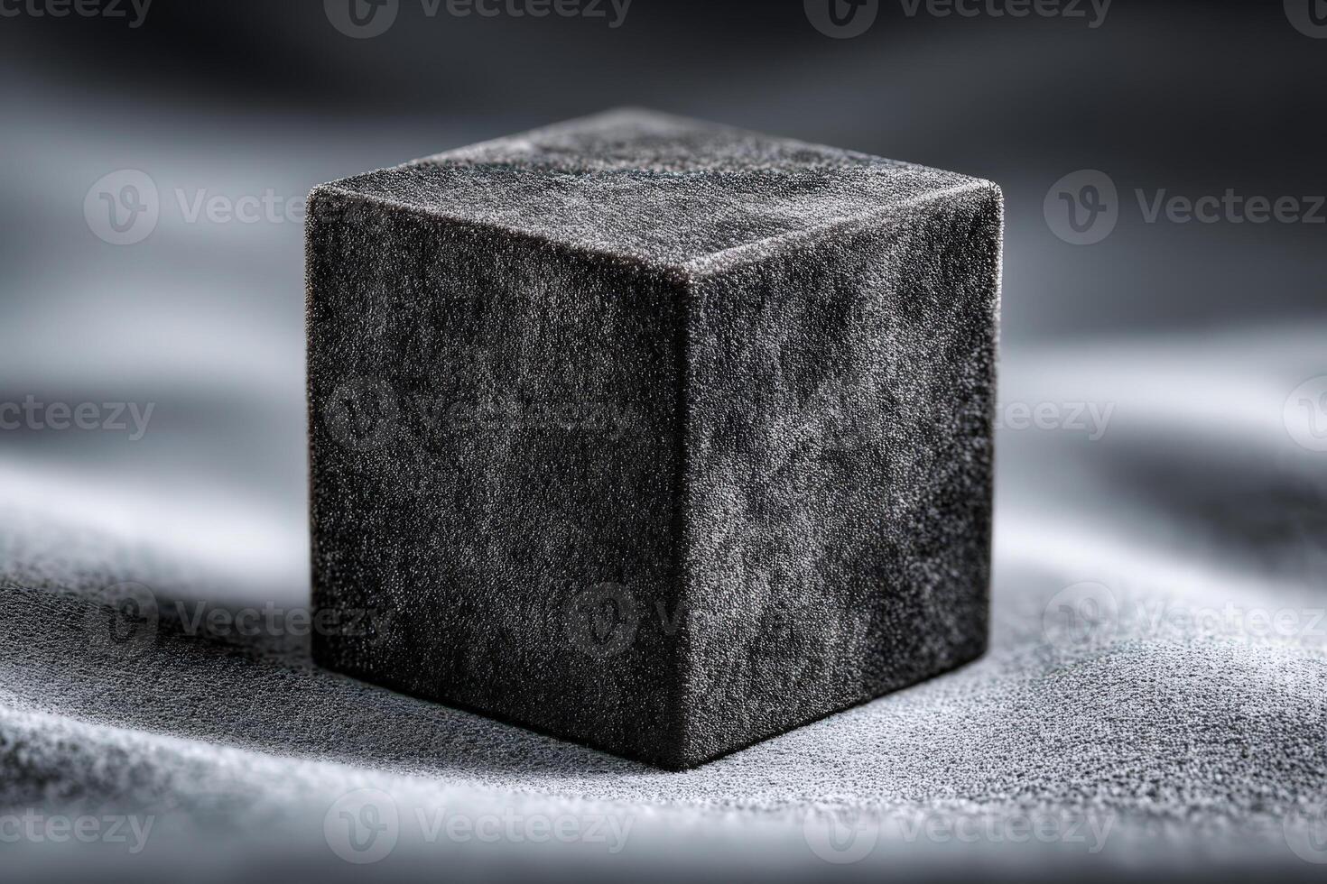 Metal cube covered in velvet with sharp edges sitting on soft fabric background photo