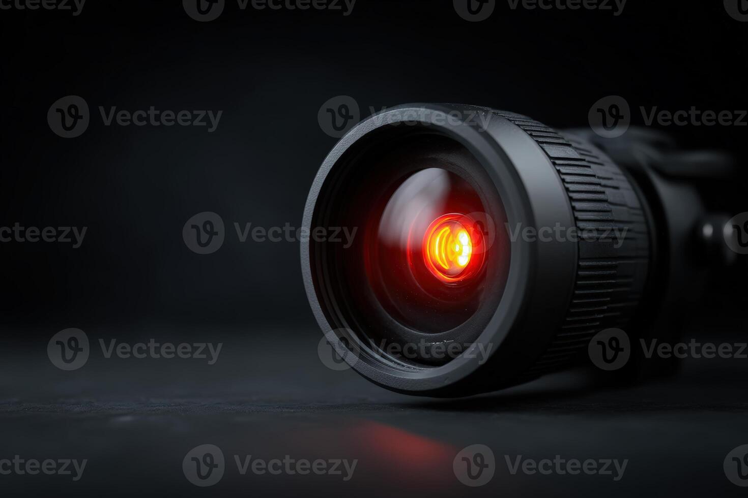Night vision CCTV lens glowing with a vivid red light captures moments in total darkness photo