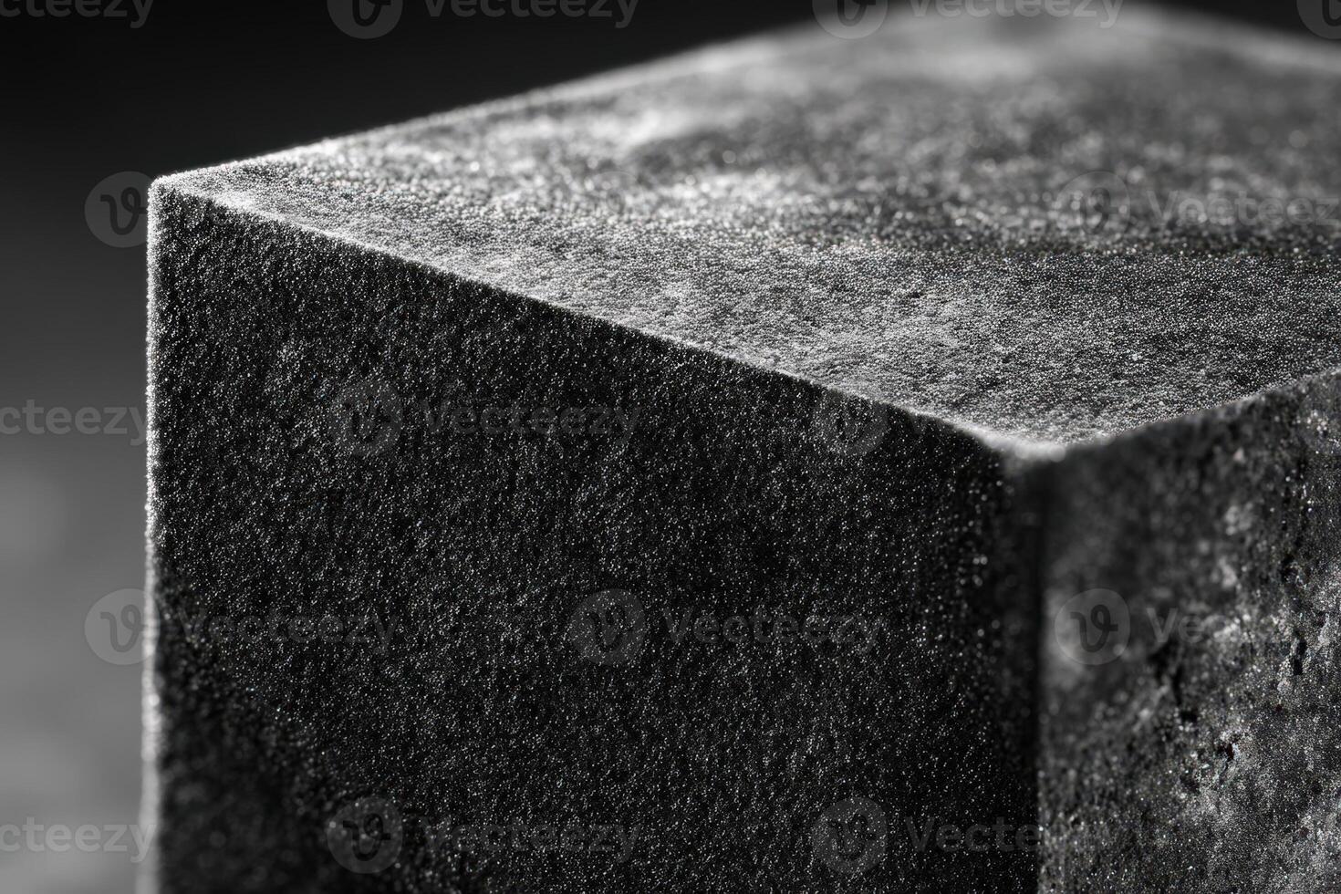 Metal cube with velvet sharp edges displayed on a dark surface photo