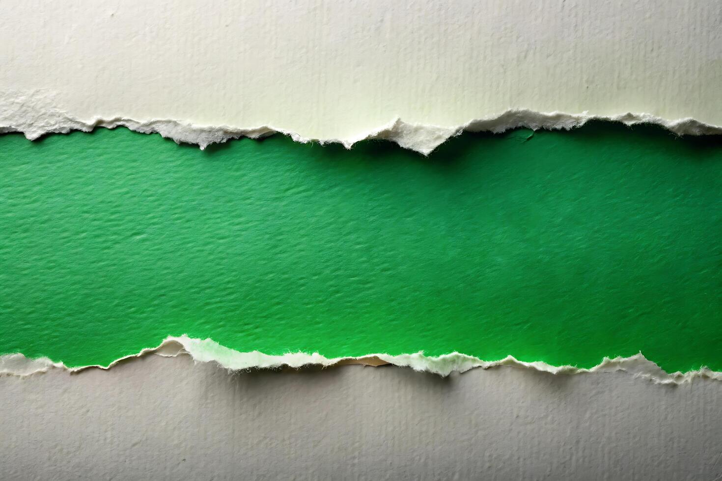 Torn paper edges reveal vibrant green background for creative use photo