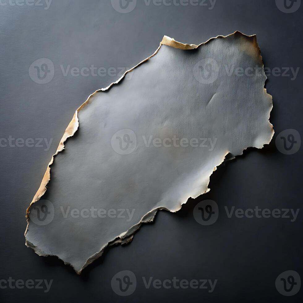 Abstract Torn Paper Sheet with Burnt Edges on Dark Gray Background photo