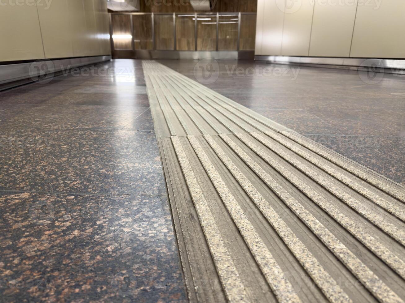 Tactile paving for visually impaired pedestrians installed in a public transport facility, highlighting modern inclusive infrastructure and urban accessibility in contemporary city design photo