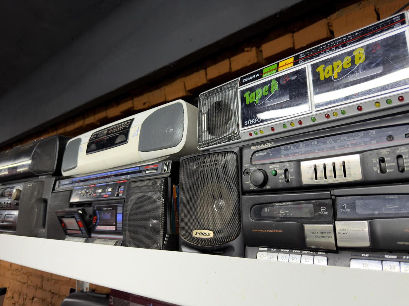 Moscow, Russia, April 27, 2025 Row of vintage boomboxes with handwritten cassette deck labels and tactile buttons, capturing the nostalgic spirit of 1980s Japanese audio design photo