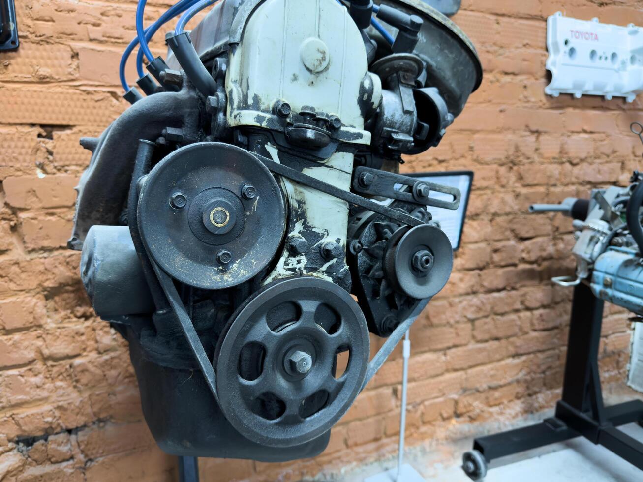Moscow, Russia, April 27, 2025 Front view of classic Japanese car engine with visible pulleys, belts and drive components, highlighting raw mechanical symmetry and engineering design of the era photo