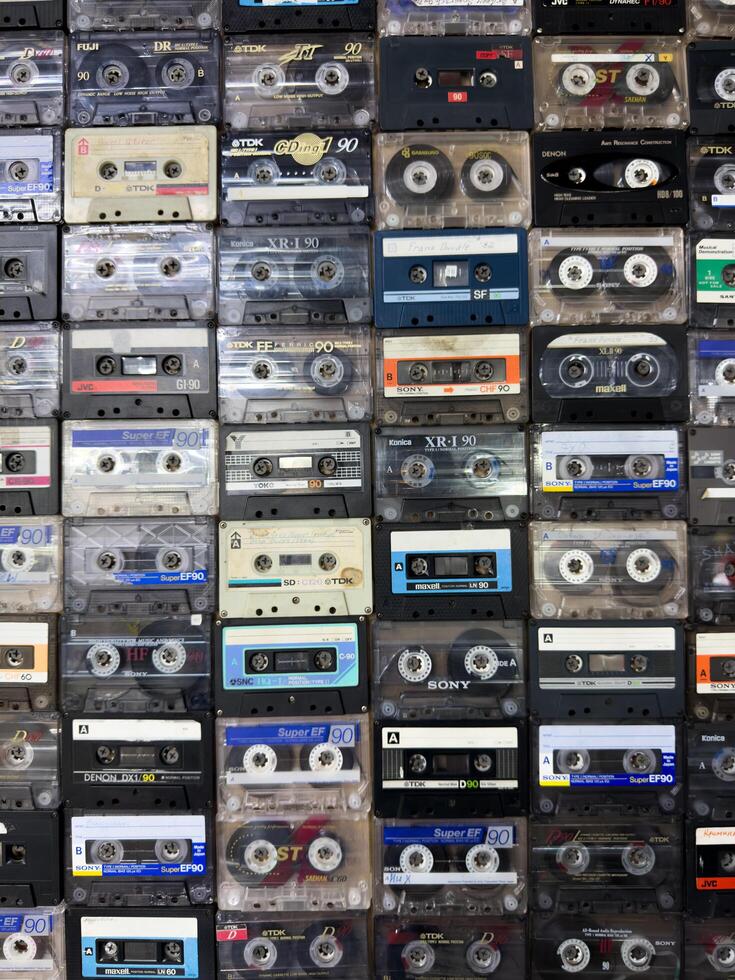 Moscow, Russia, April 27, 2025 Vertical retro background of vintage audio cassettes arranged in rows, ideal for nostalgic designs, music themed layouts or creative visual textures photo