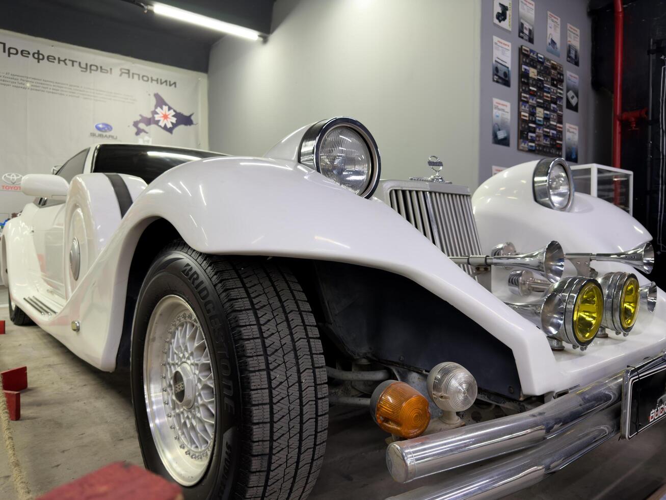 Moscow, Russia, April 27, 2025 Elegant white Mitsuoka Le Seyde. Retro style car with exaggerated fenders, chrome horns, round headlights and Bridgestone tires on BBS wheels photo