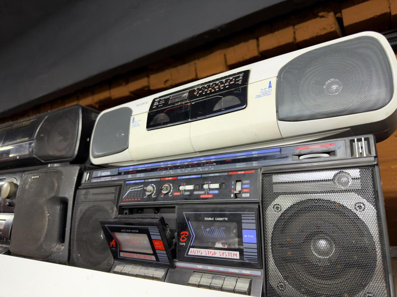 Moscow, Russia, April 27, 2025 Classic Sony and National portable boomboxes from the cassette era displayed with open tape decks, showcasing vintage audio technology in a retro themed collection photo