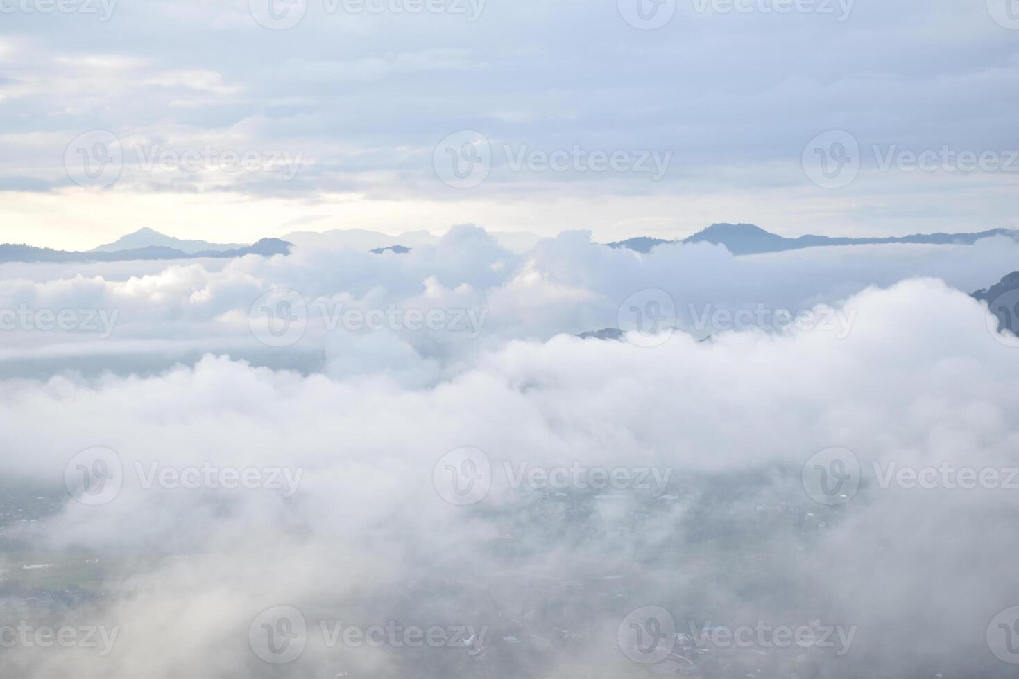 A plane flying over a city with clouds photo