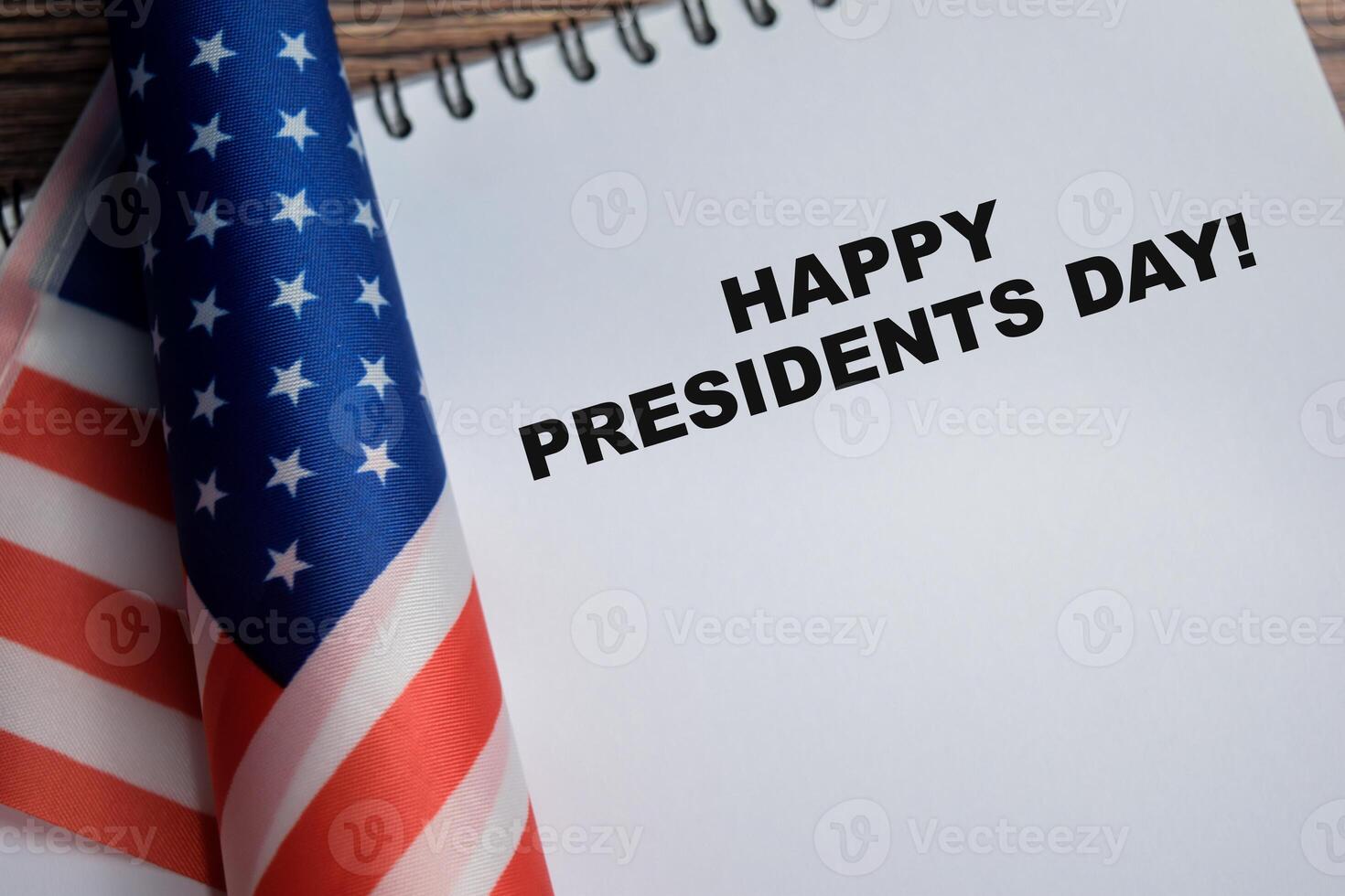 Concept of happy presidents day write on book and american flag isolated on Wooden Table. photo
