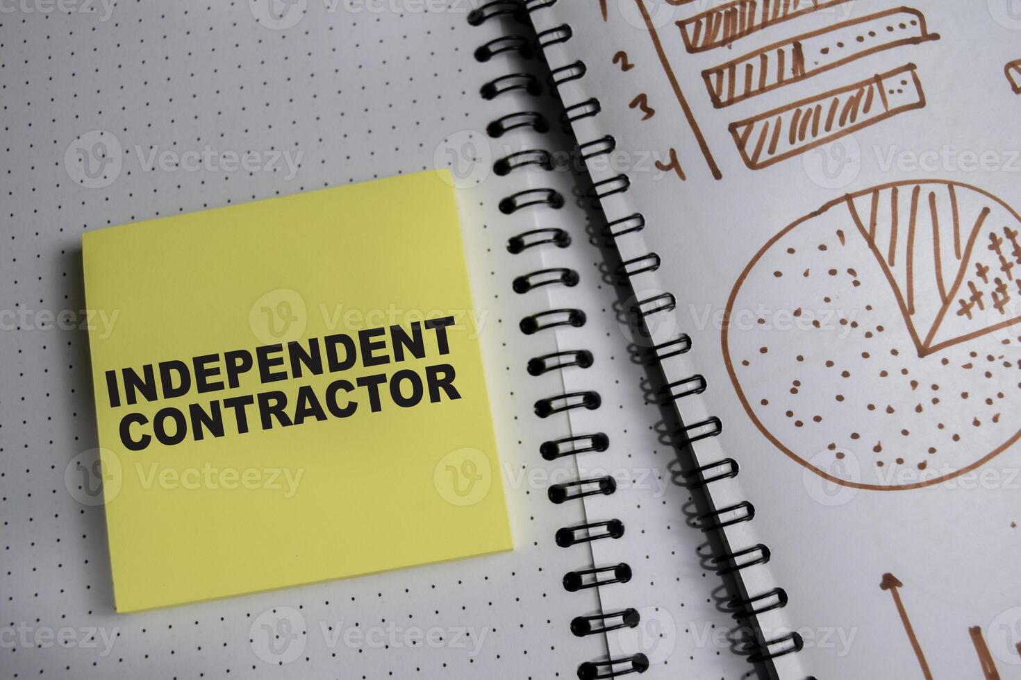 Concept of Independent contractor write on book and chart isolated on Wooden Table. photo