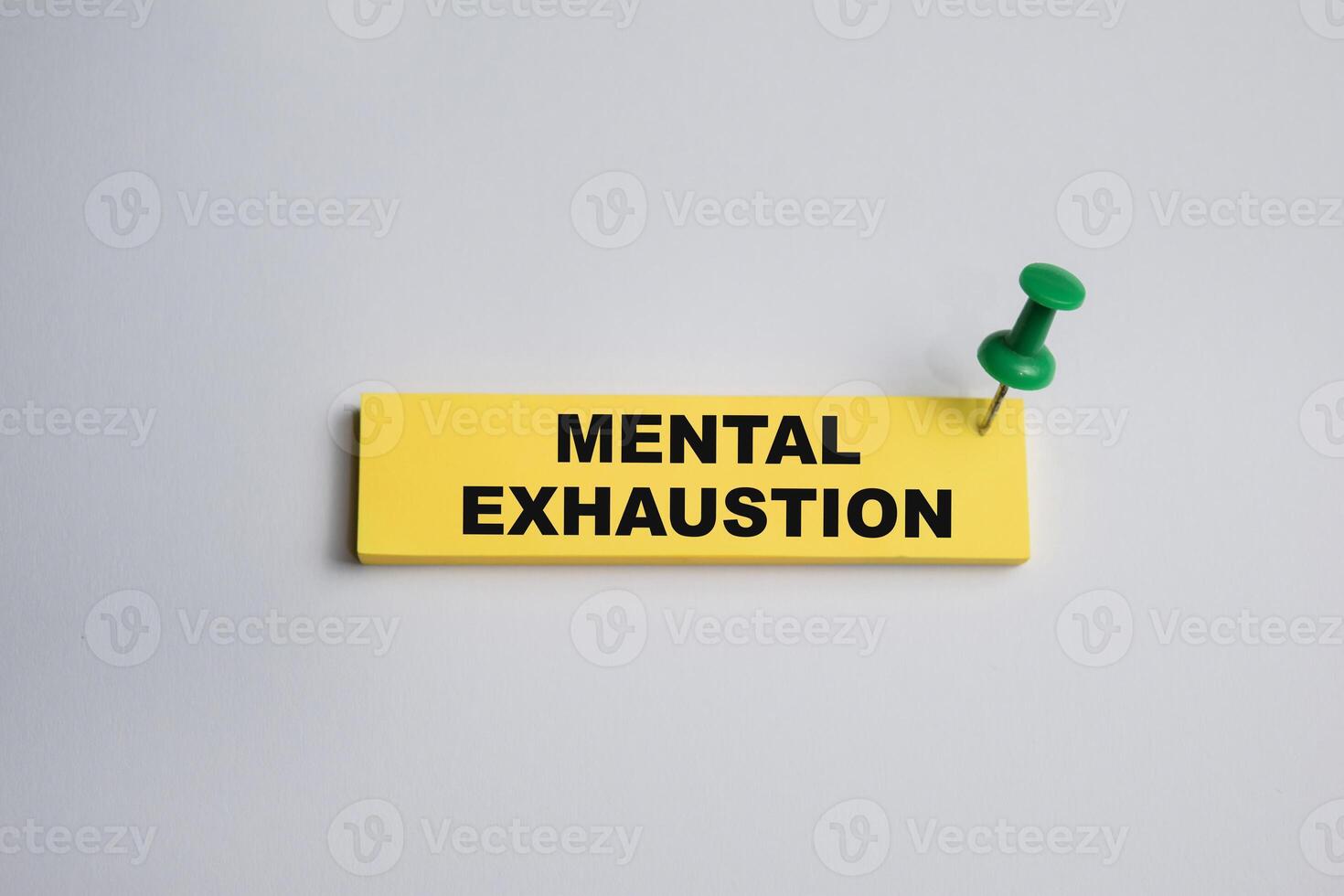 Concept of Mental exhaustion write on sticky notes isolated on Wooden Table. photo