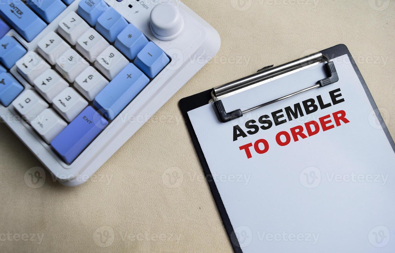 Concept of Assemble to order write on clipboard isolated on Wooden Table. photo