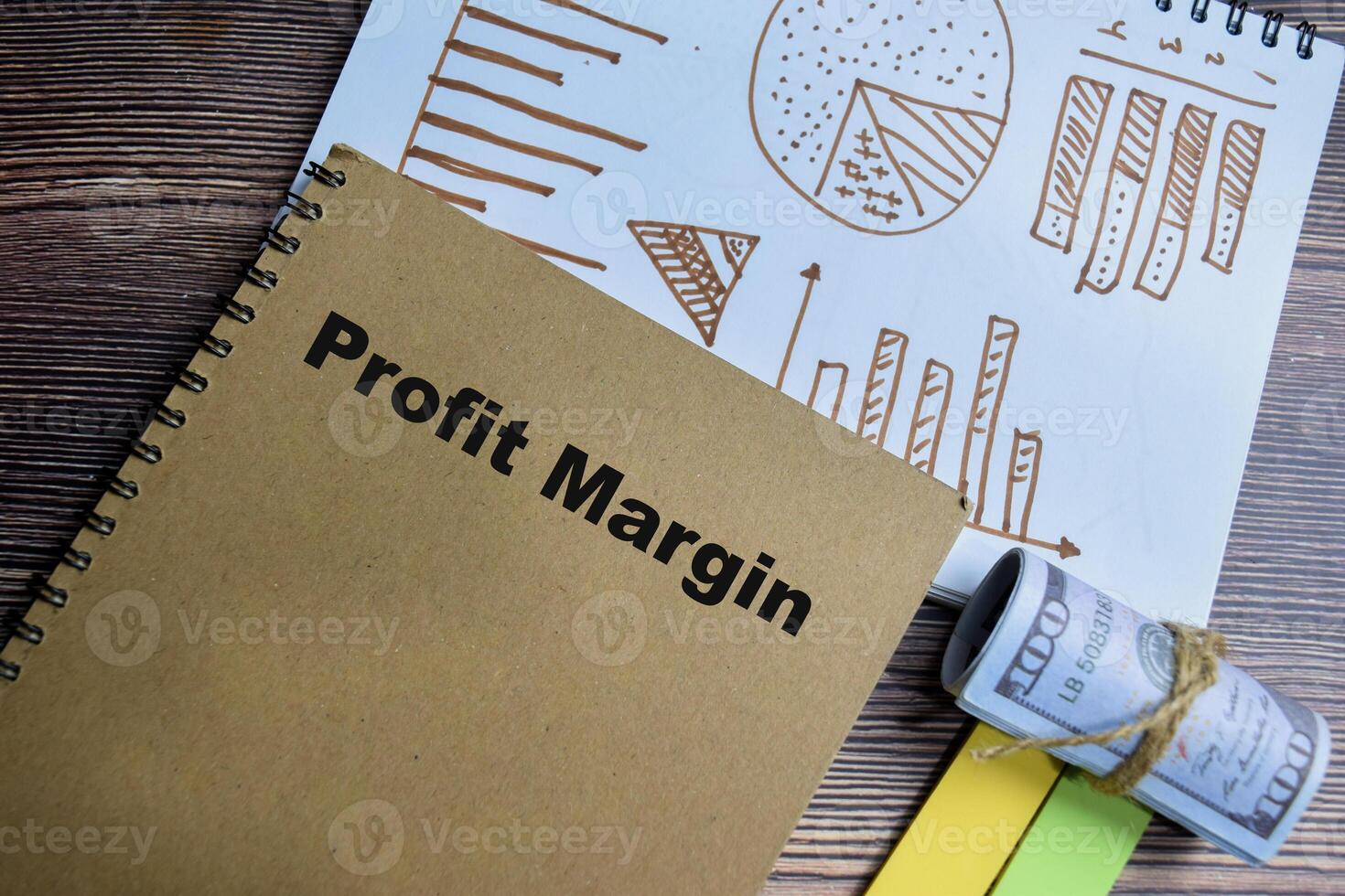 Concept of profit margin and chart write on book isolated on Wooden Table. photo