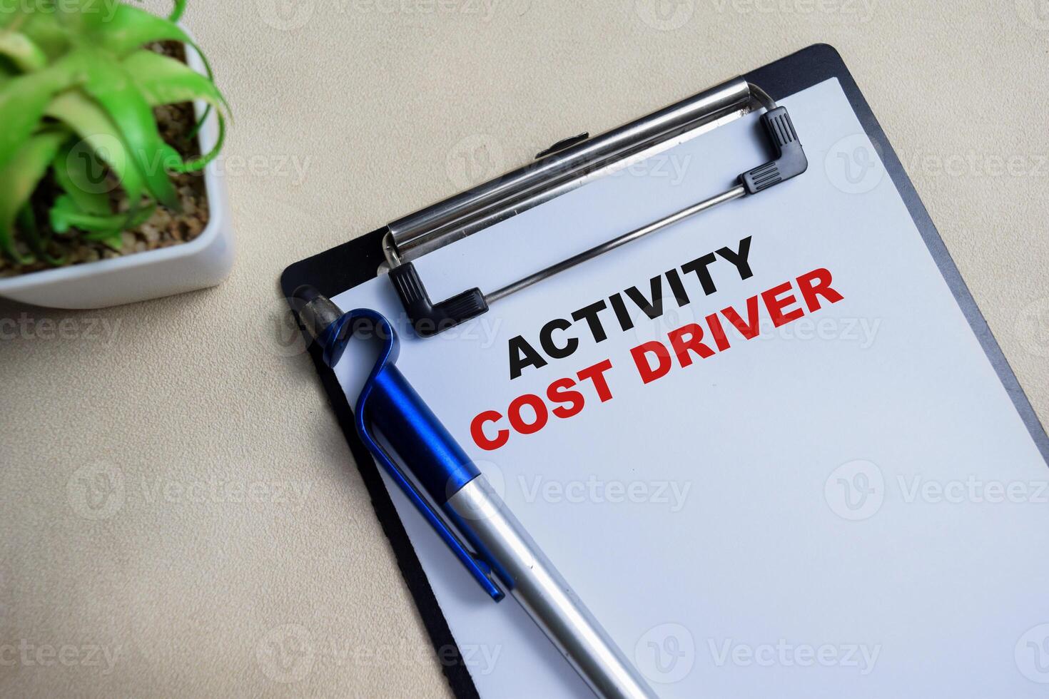 Concept of Activity cost driver write on clipboard isolated on Wooden Table. photo