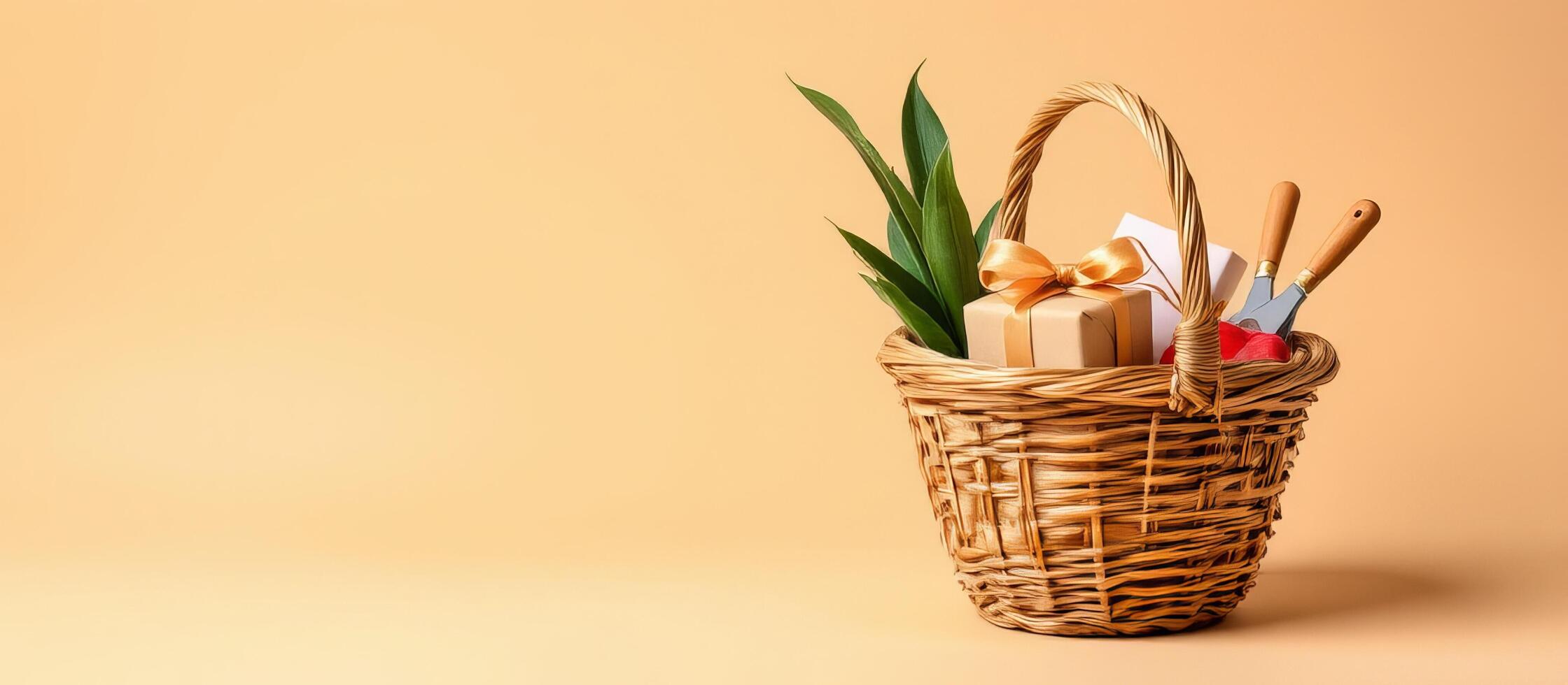 Gift basket with green leaves and gardening tools on beige background photo