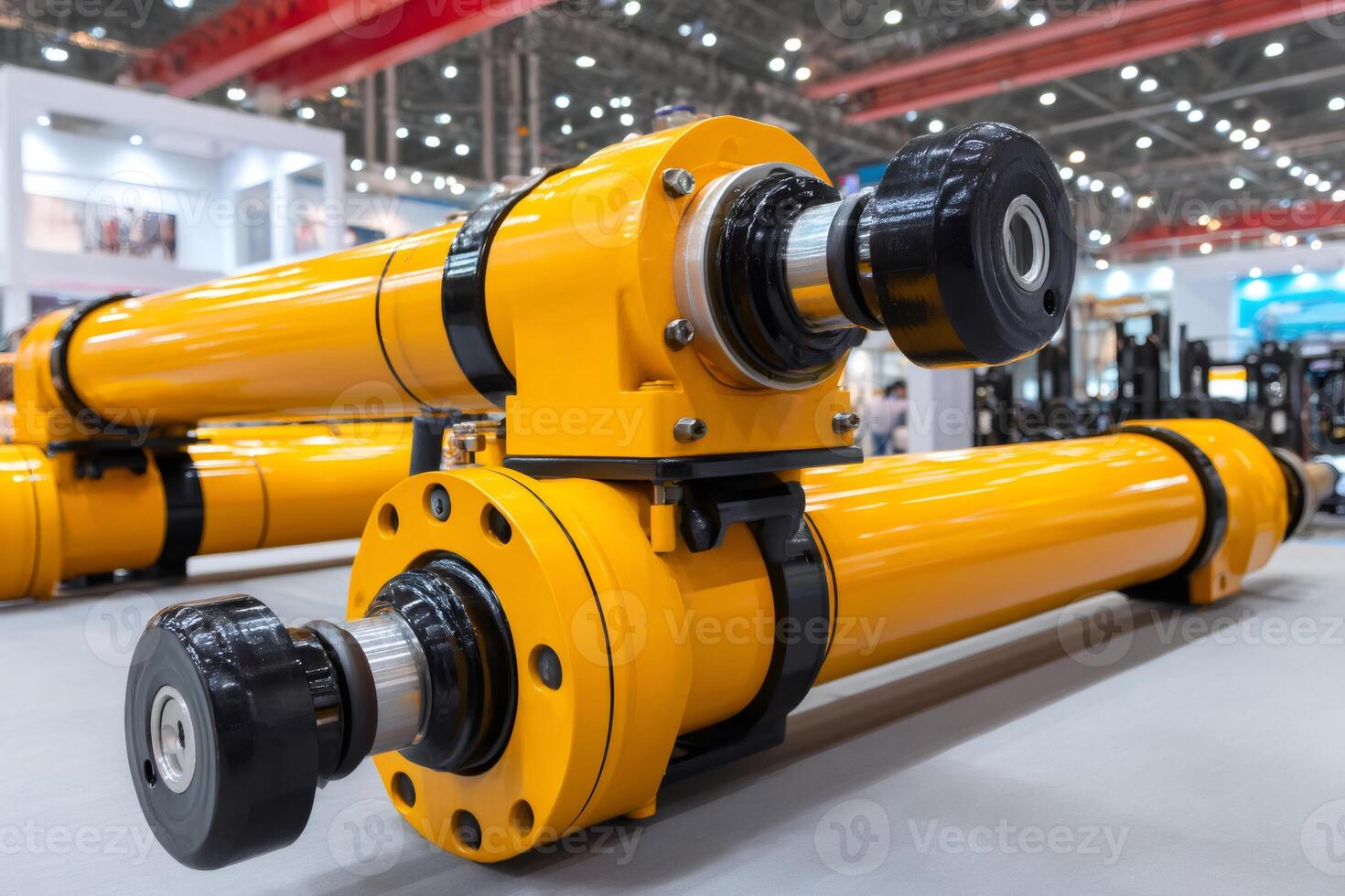 Powerful yellow hydraulic cylinders standing on display at a trade show photo