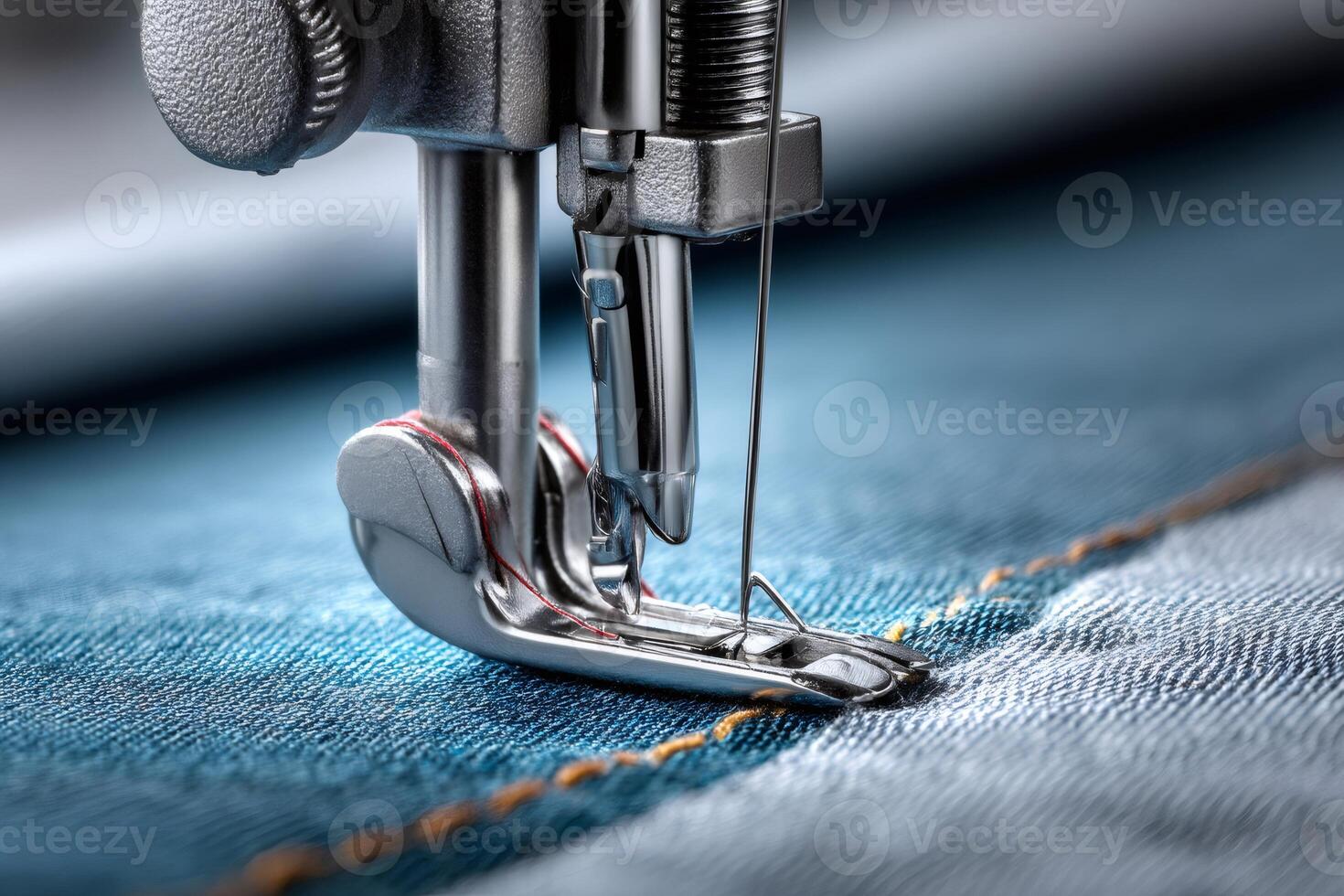 Sewing machine stitching blue denim fabric, close up view of industrial needle photo