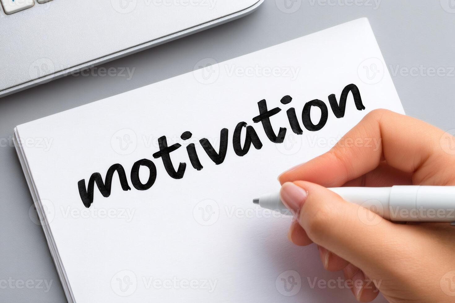 Woman writing motivation on a notepad with a marker pen photo