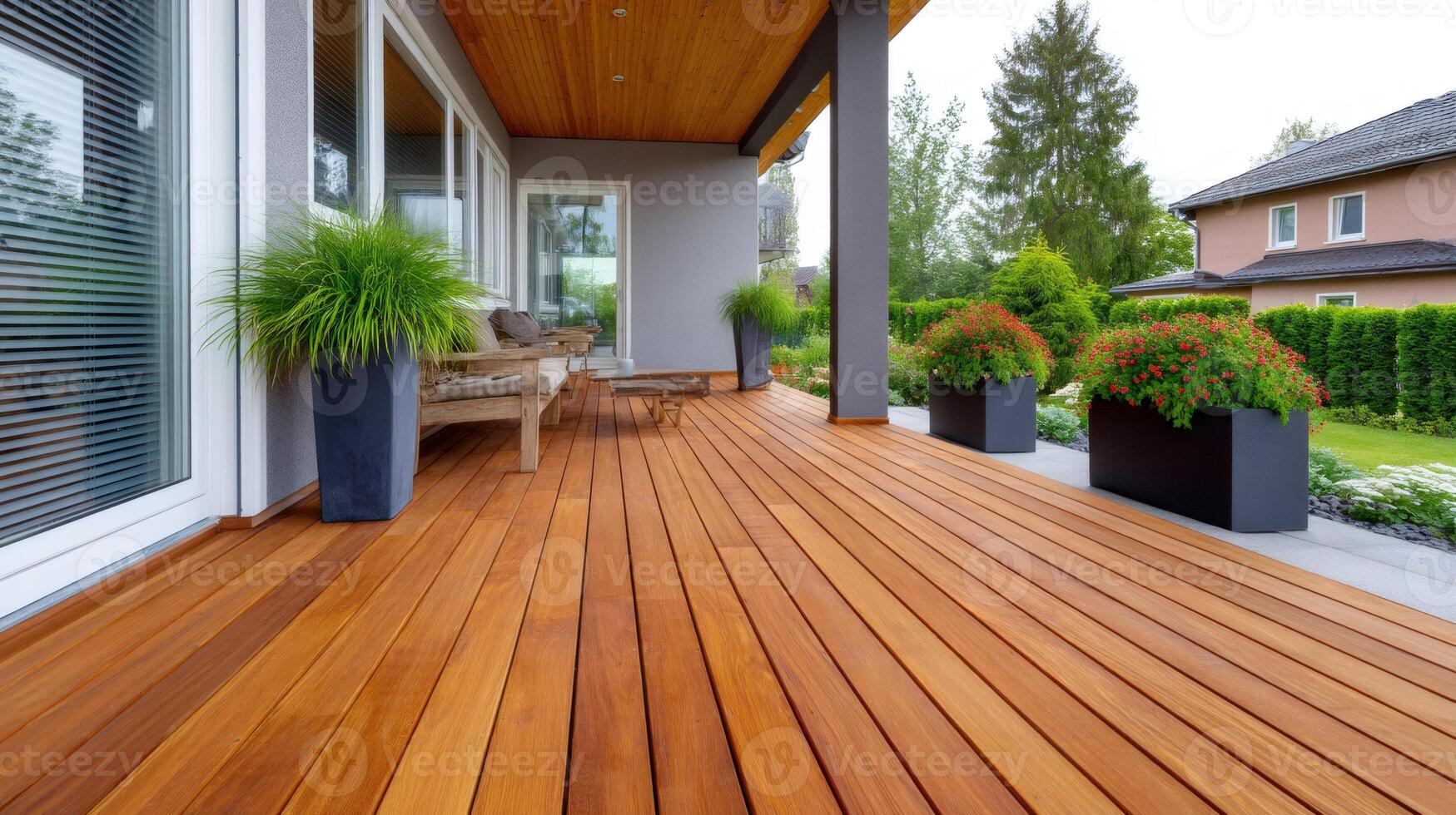 Wooden terrace with flower pots connecting house and garden photo