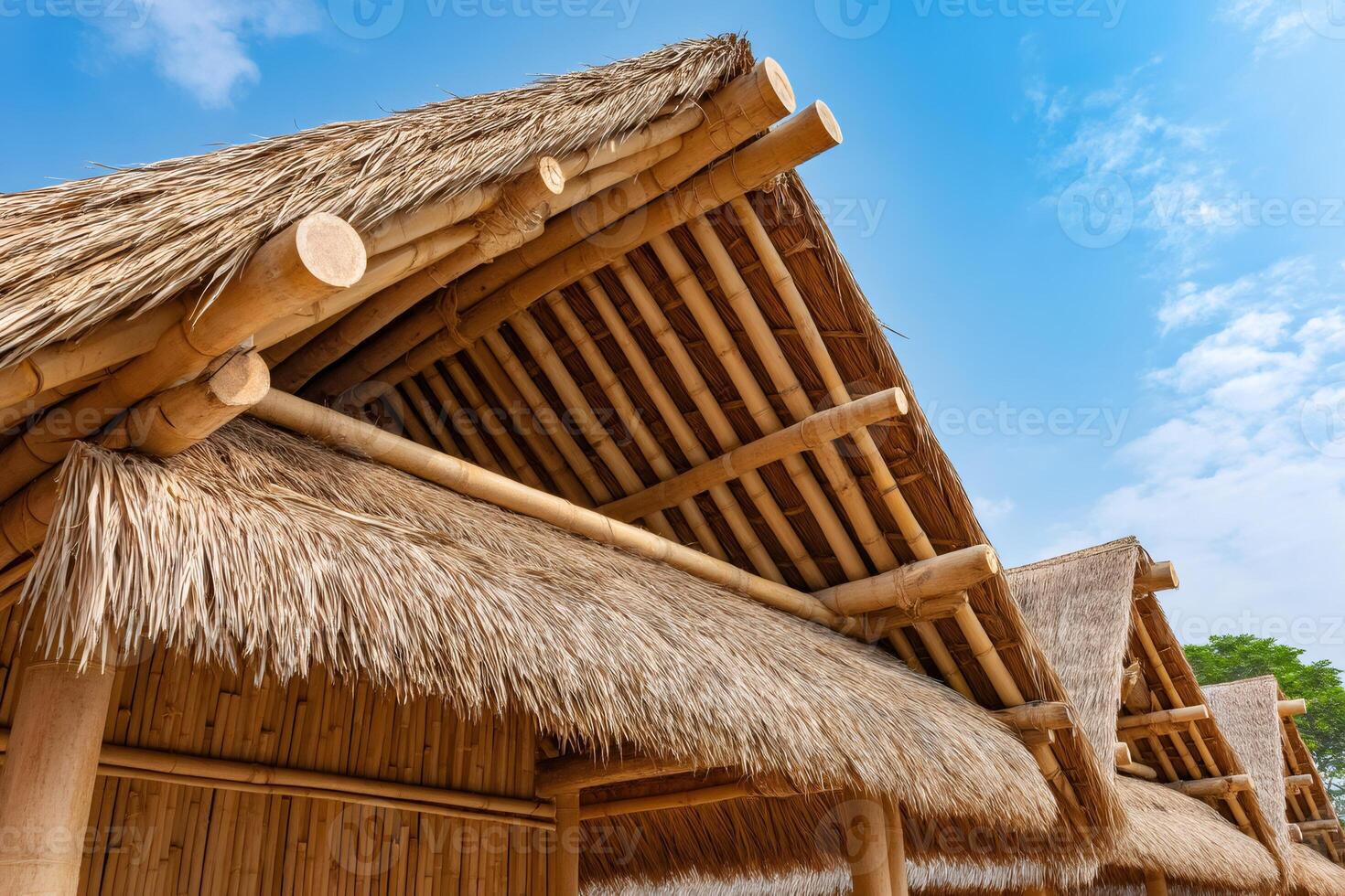 Bamboo and thatch roof creating a tropical paradise under blue sky photo