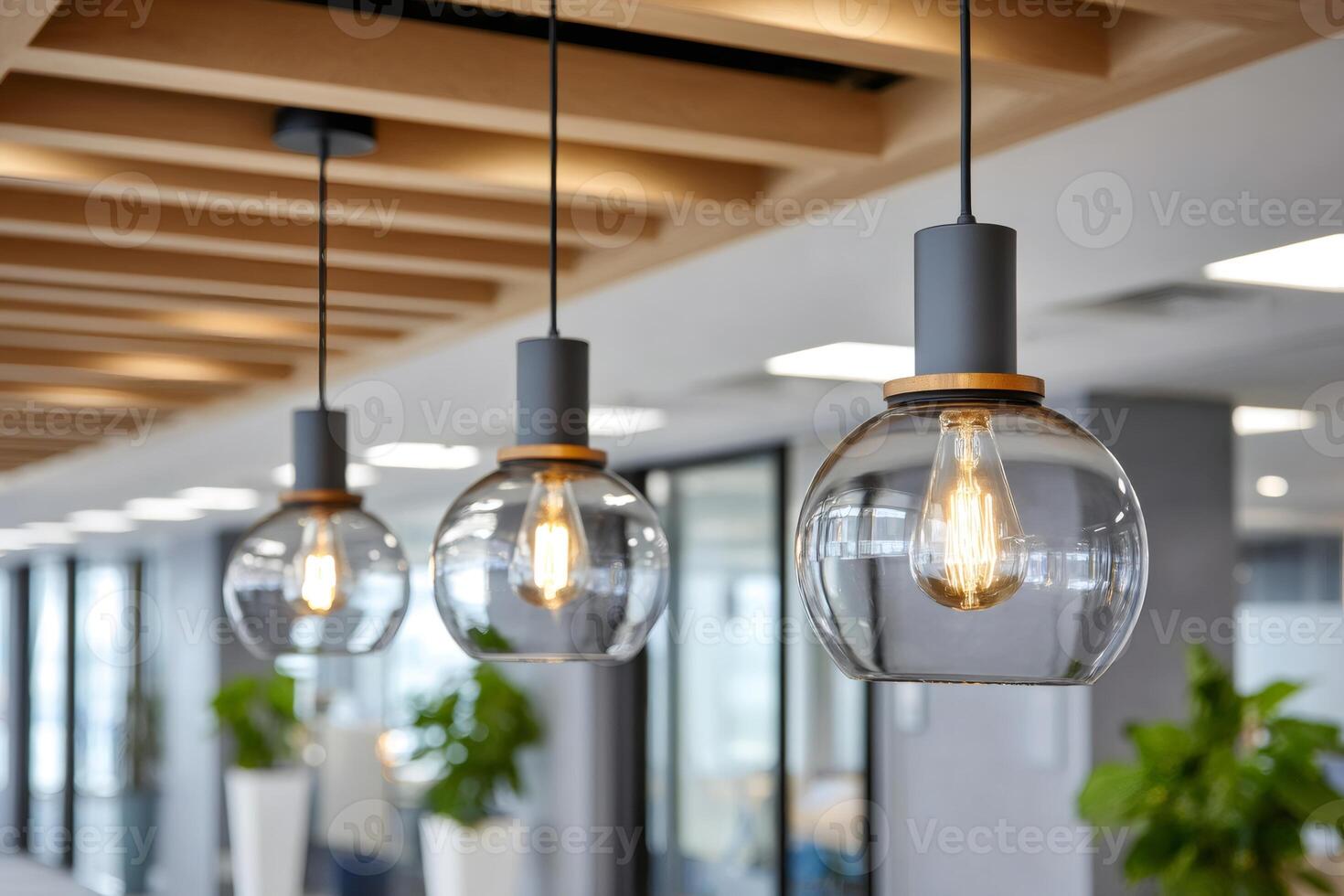 Modern glass lamps hanging from wooden ceiling in office photo