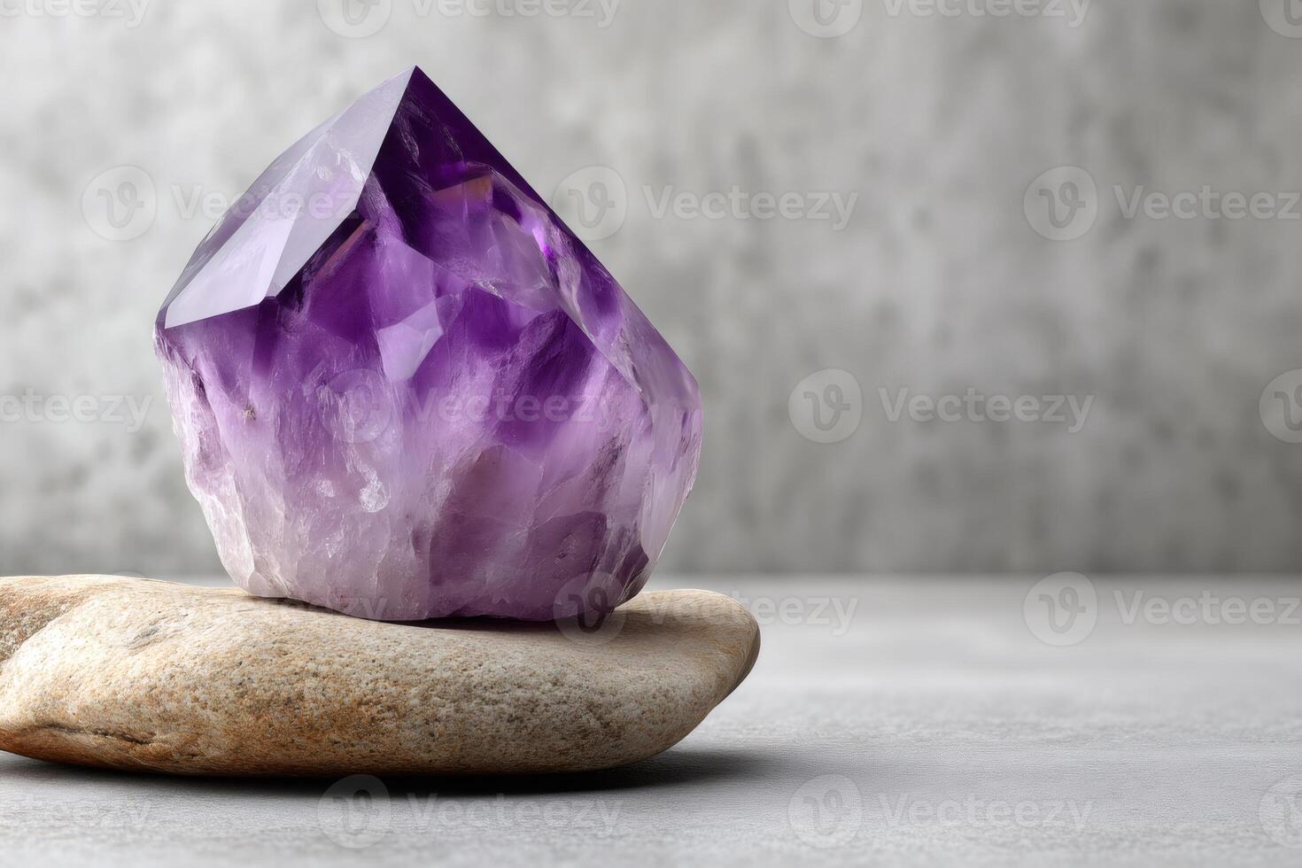 Large amethyst crystal standing on a rock for healing and meditation photo