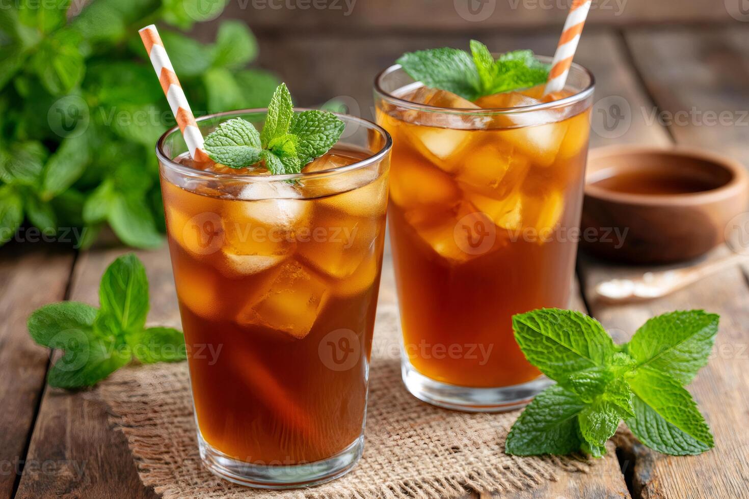 Refreshing iced tea with fresh mint and ice cubes on rustic wooden table photo