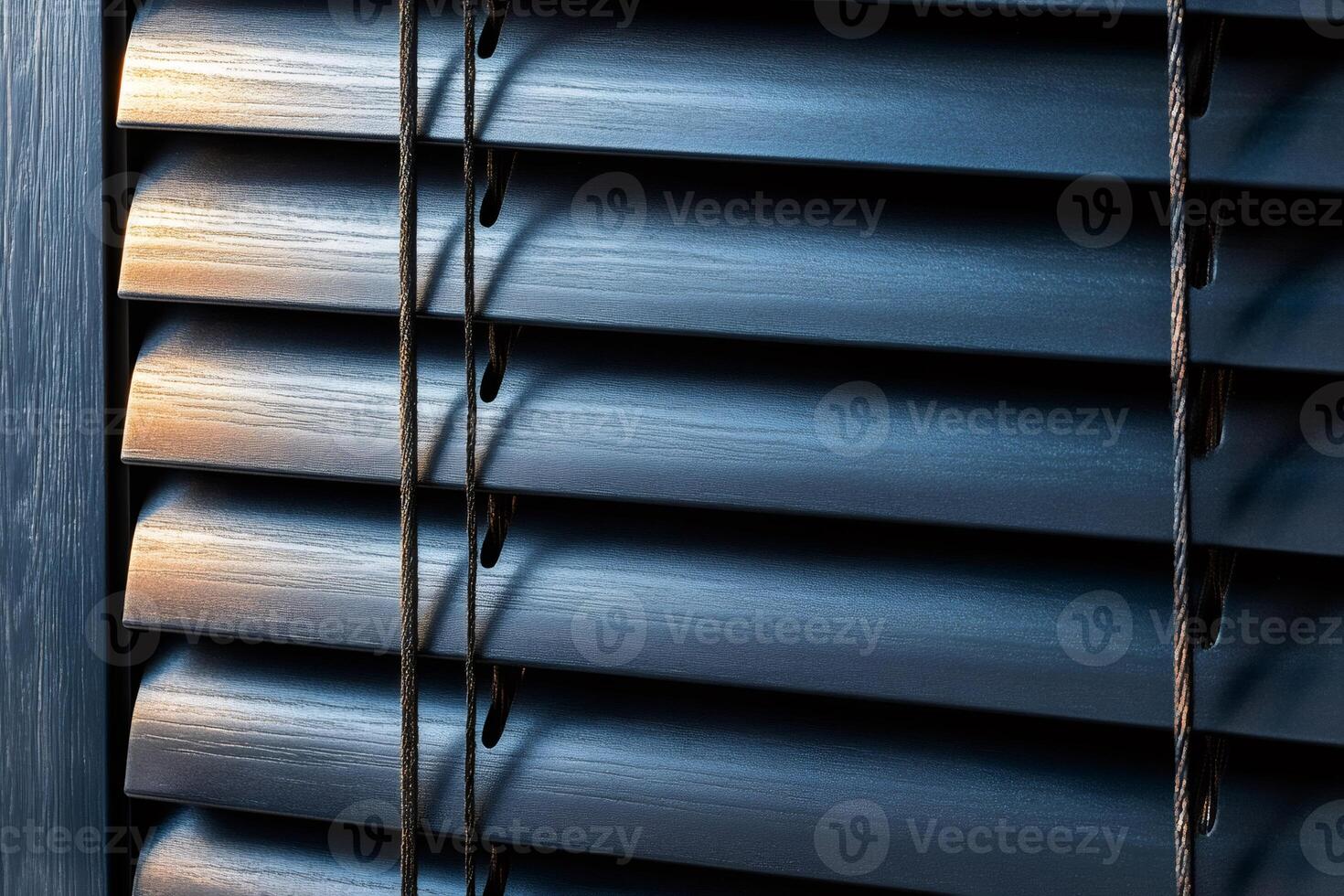 Modern venetian blinds partially covering window, providing shade and privacy photo