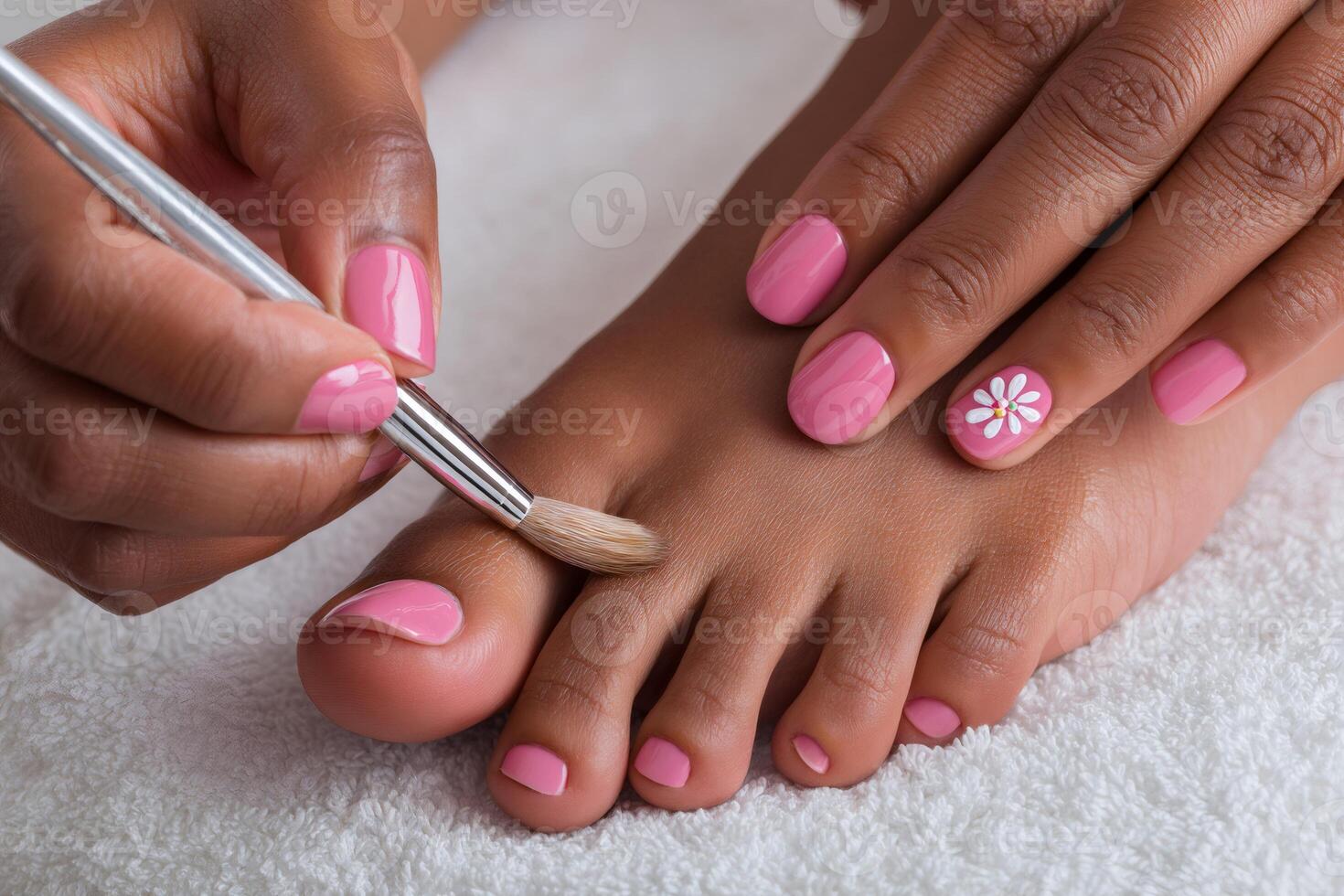Beautician applying nail polish on toenails during pedicure treatment photo