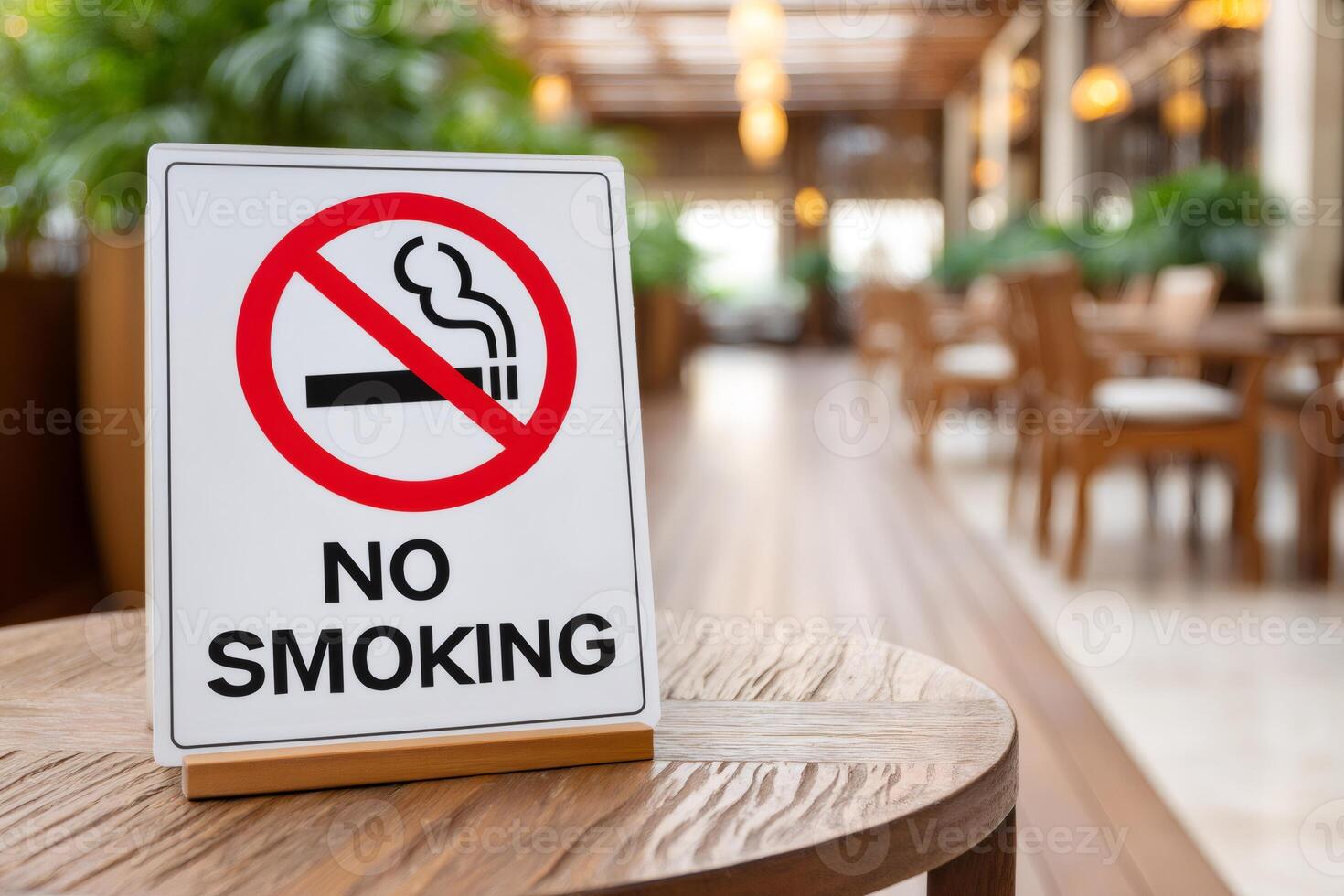 No smoking sign displayed on table in blurred restaurant interior photo