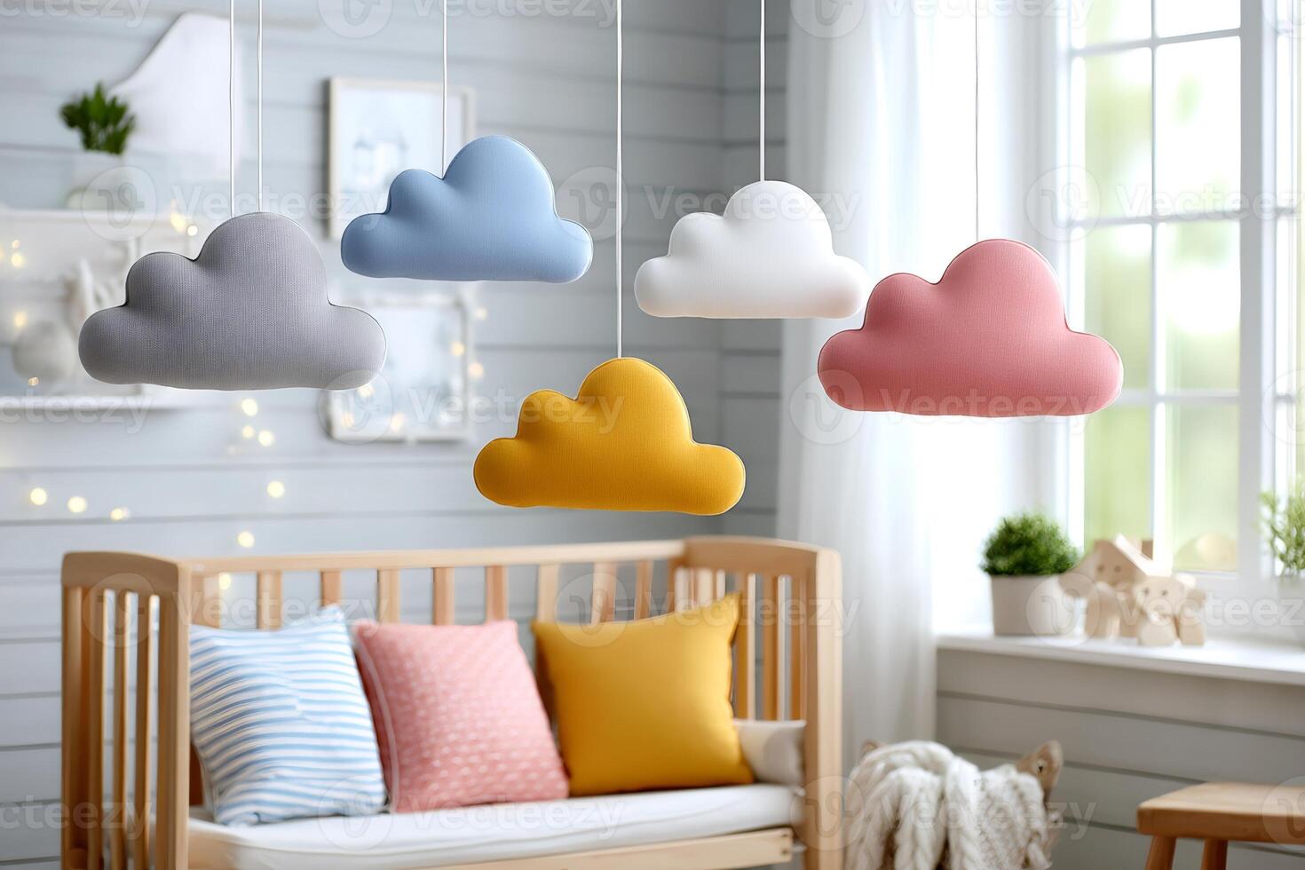 Colorful cloud shaped hanging decorations in baby room photo